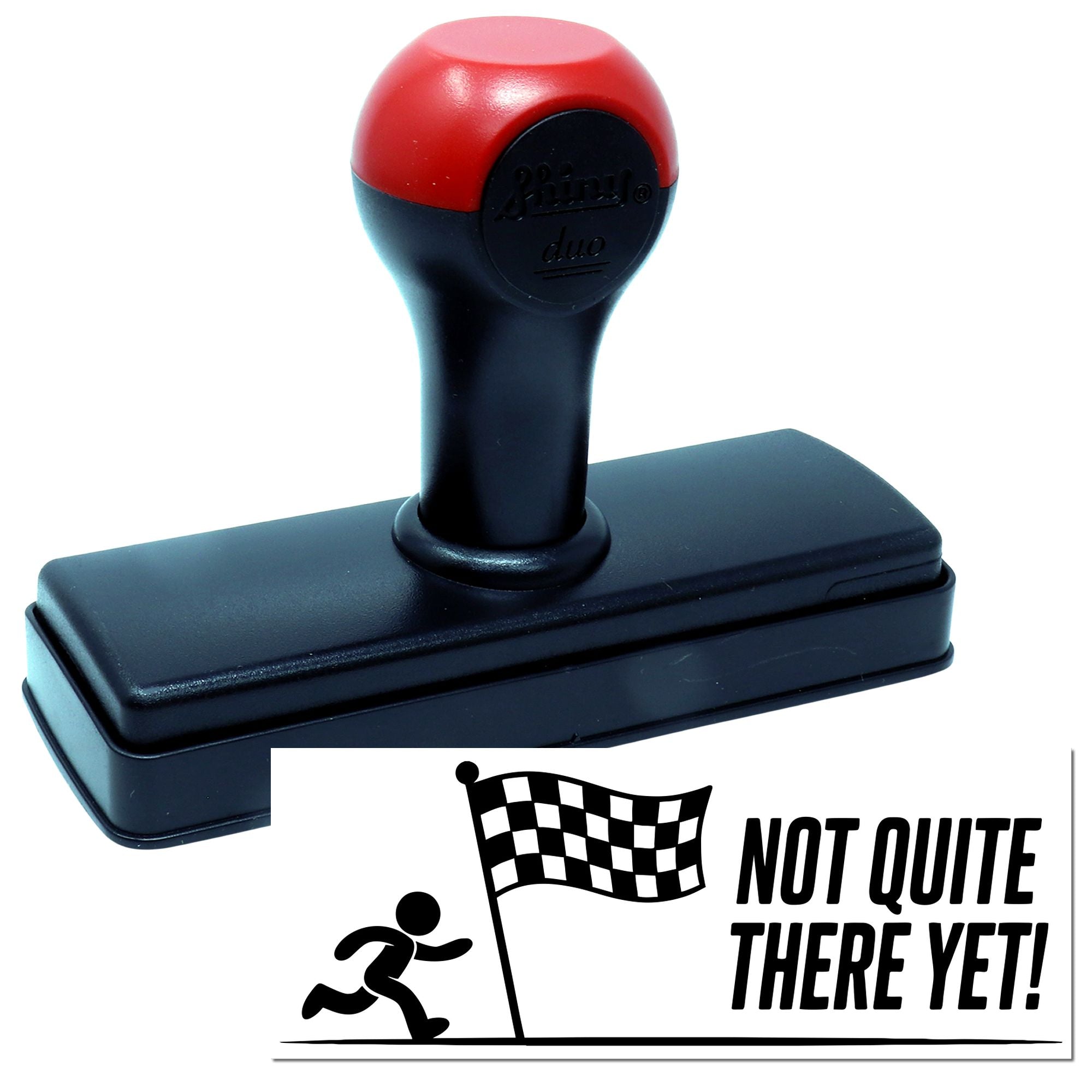 Red and black self-inking stamp and seal with checkered flag graphic and Not Quite There Yet! text