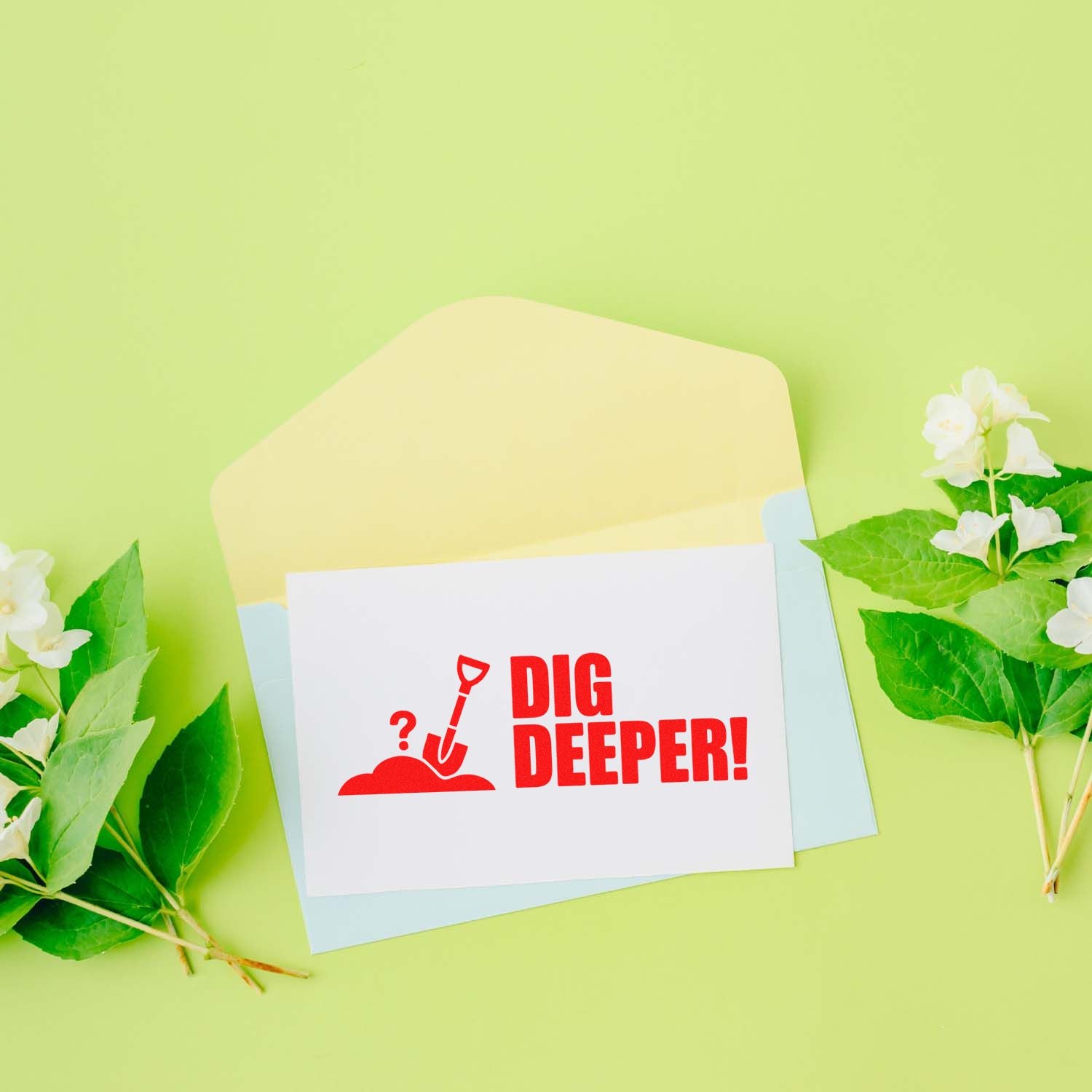 Red DIG DEEPER! stamp design on white card with pastel envelopes, light green background, white flowers and green leaves.