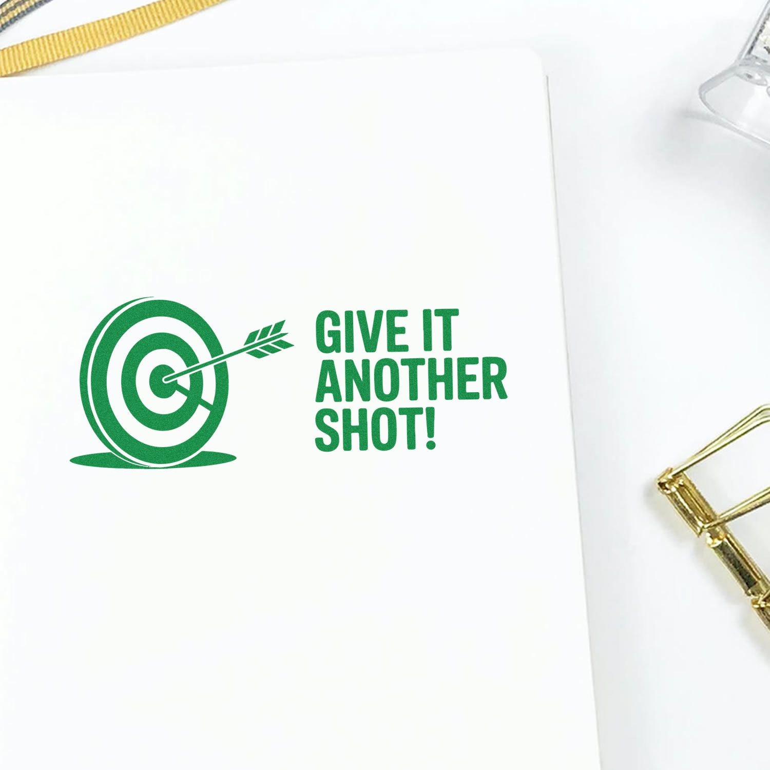 Green custom stamp and seal with target arrow design and GIVE IT ANOTHER SHOT! on white background.