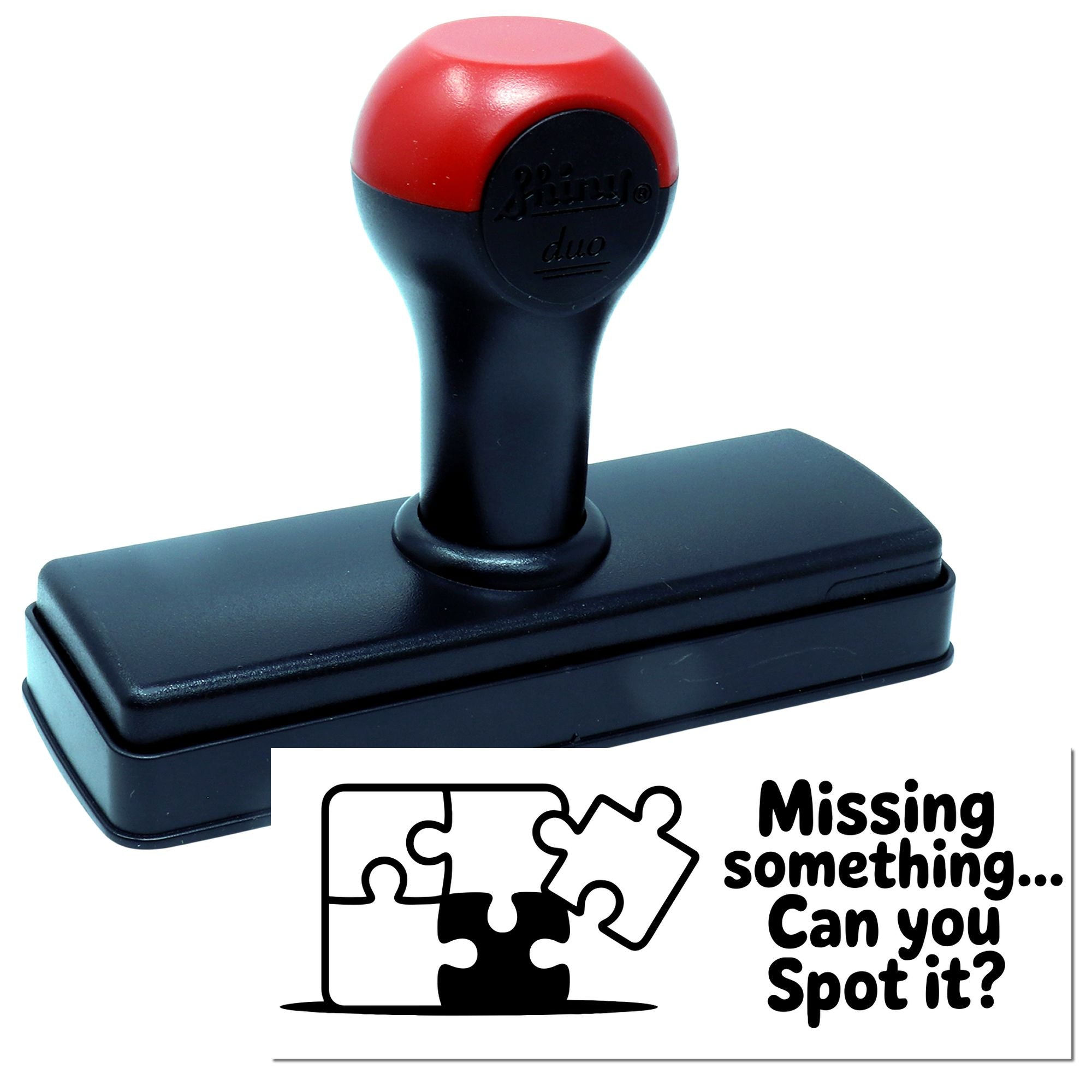 Red and black self-inking stamp seal with rectangular base and puzzle-piece graphic reading Missing something... Can you spot it?