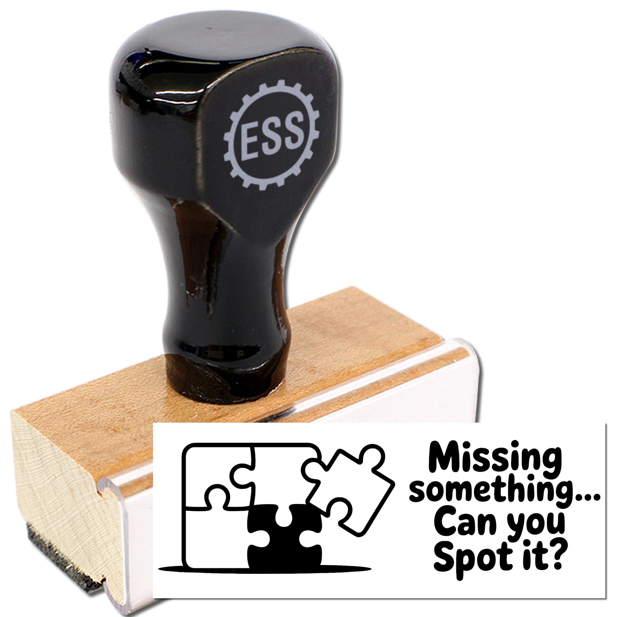 Black ESS rubber stamp on a wooden block with a puzzle-themed seal reading Missing something... Can you spot it?