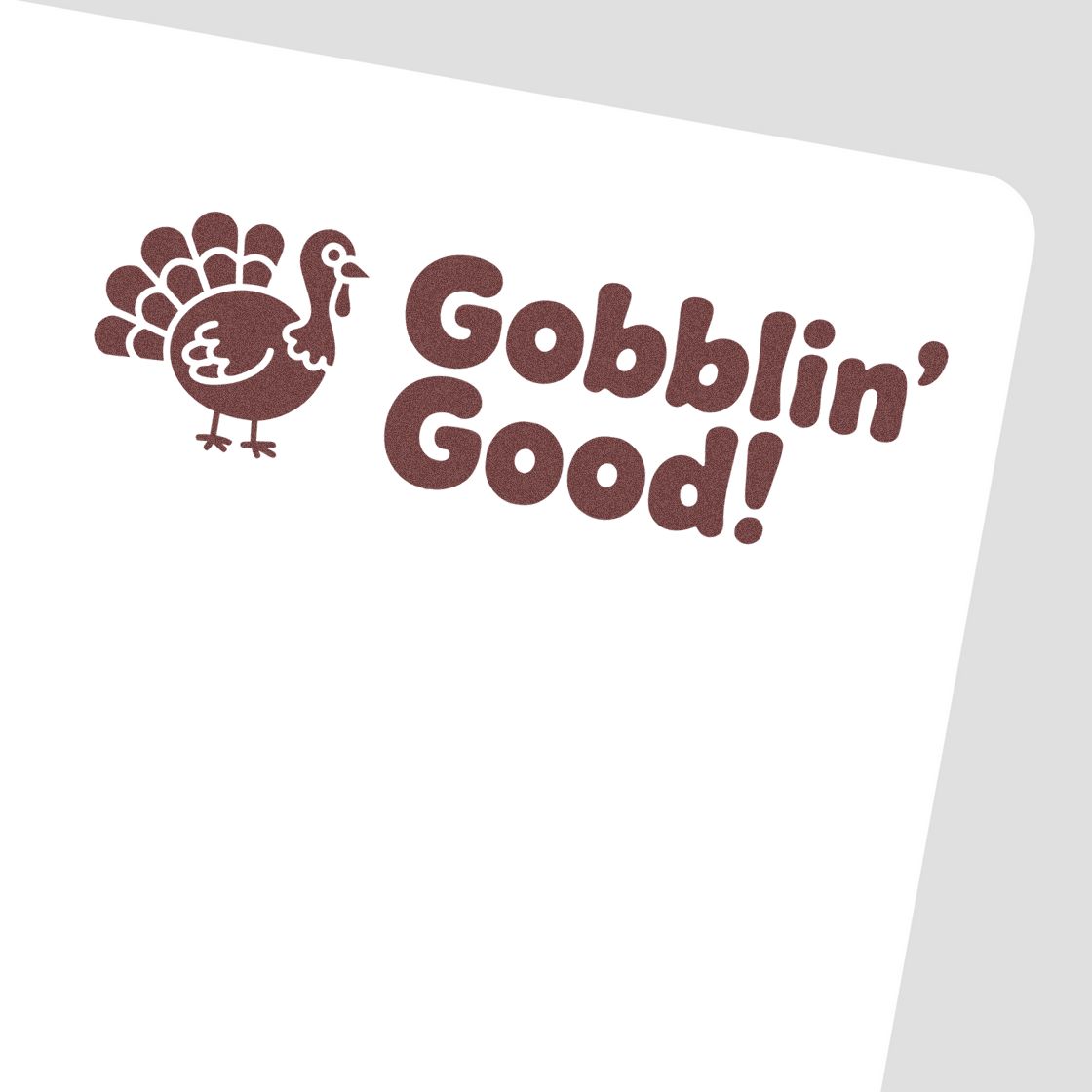 Brown turkey stamp seal reading Gobblin Good! on a white background