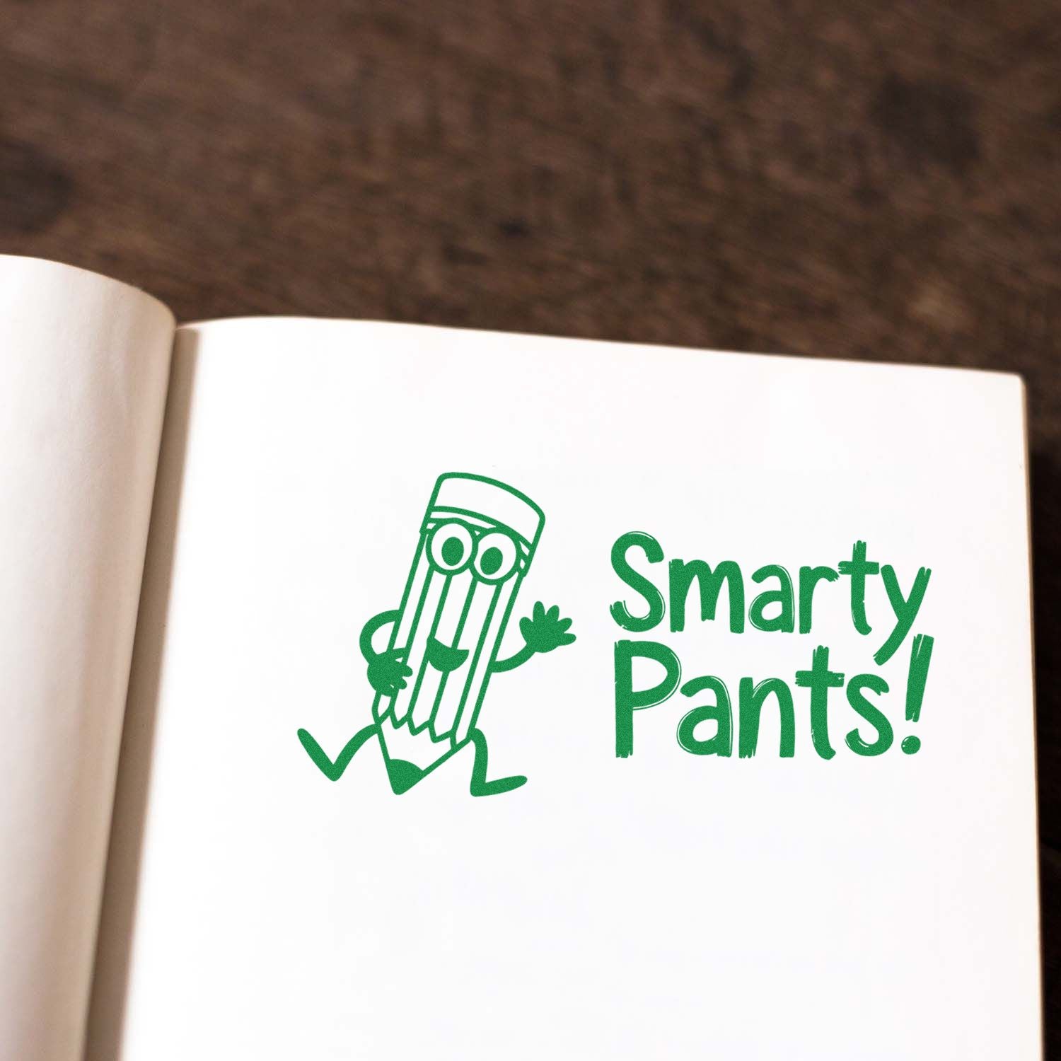 Green Smarty Pants! stamp with cartoon pencil on white page, a playful green seal product.
