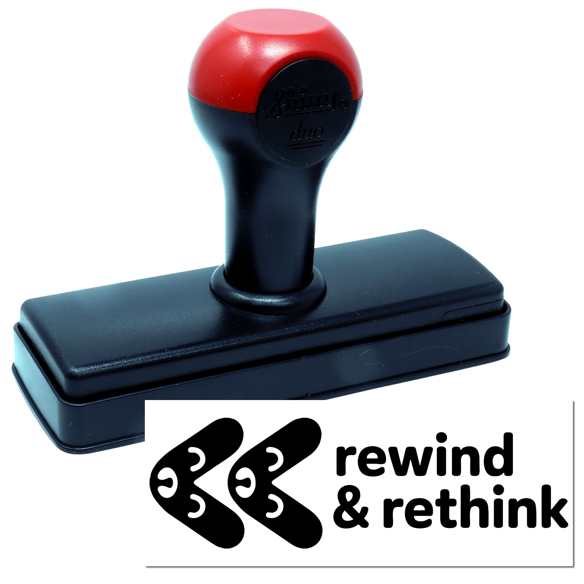 Red and black self-inking stamp and seal with rounded handle and base, plus rewind & rethink logo card.