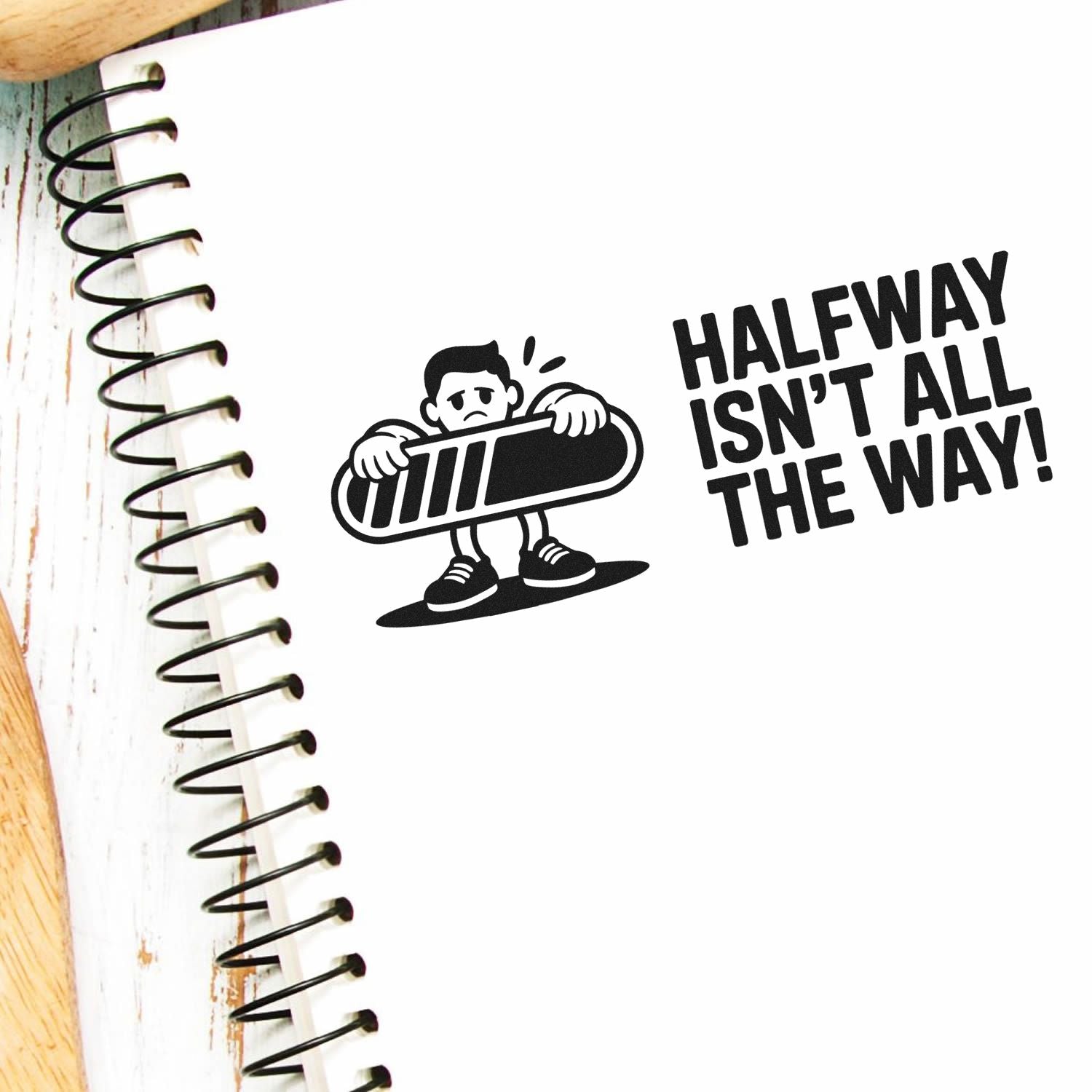 Black stamp-and-seal design on white notebook, cartoon holding a half-finished bar beside bold text: Halfway isnt all the way!