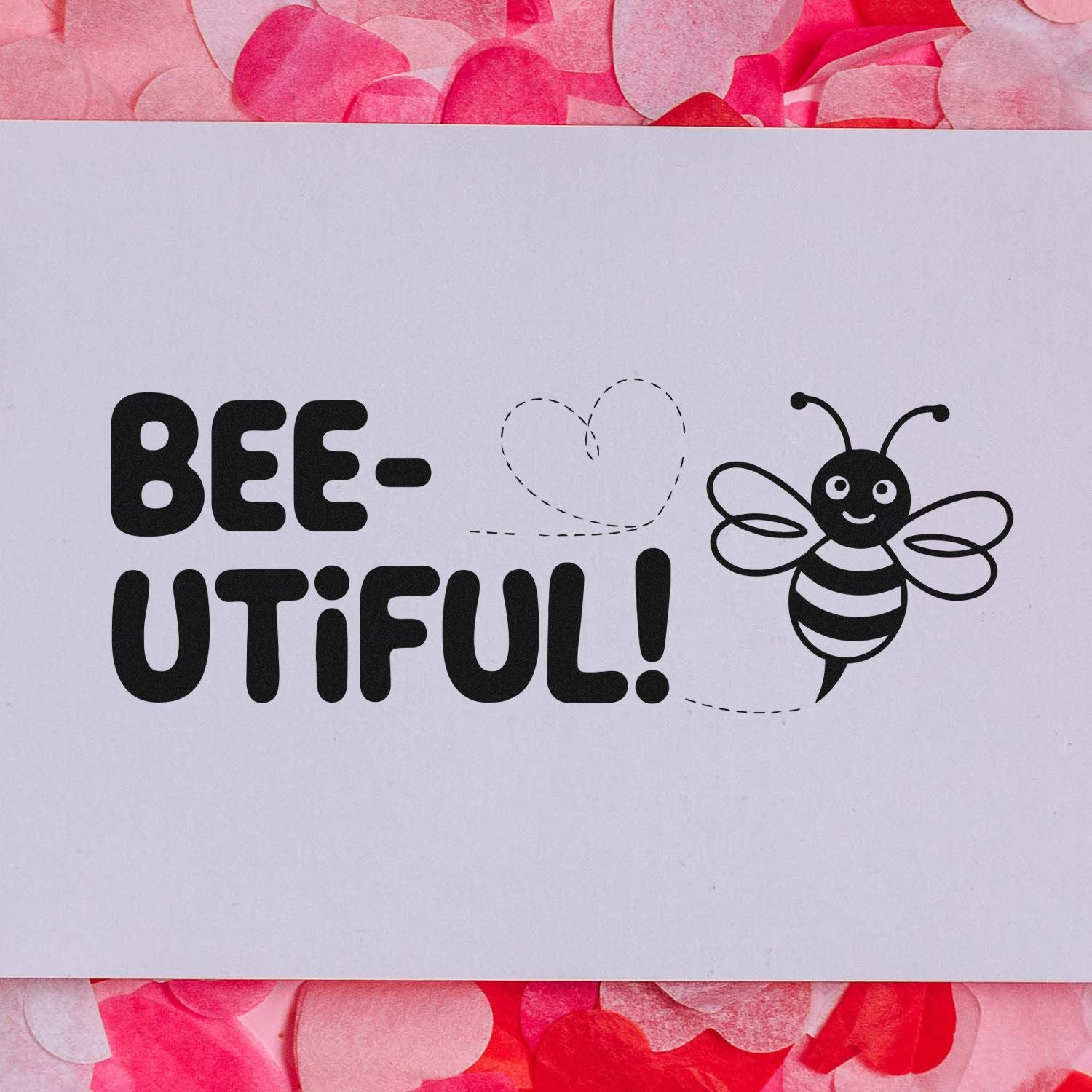 Bee-themed stamp and seal design with black smiling bee, dotted heart, on white background with pink floral border.