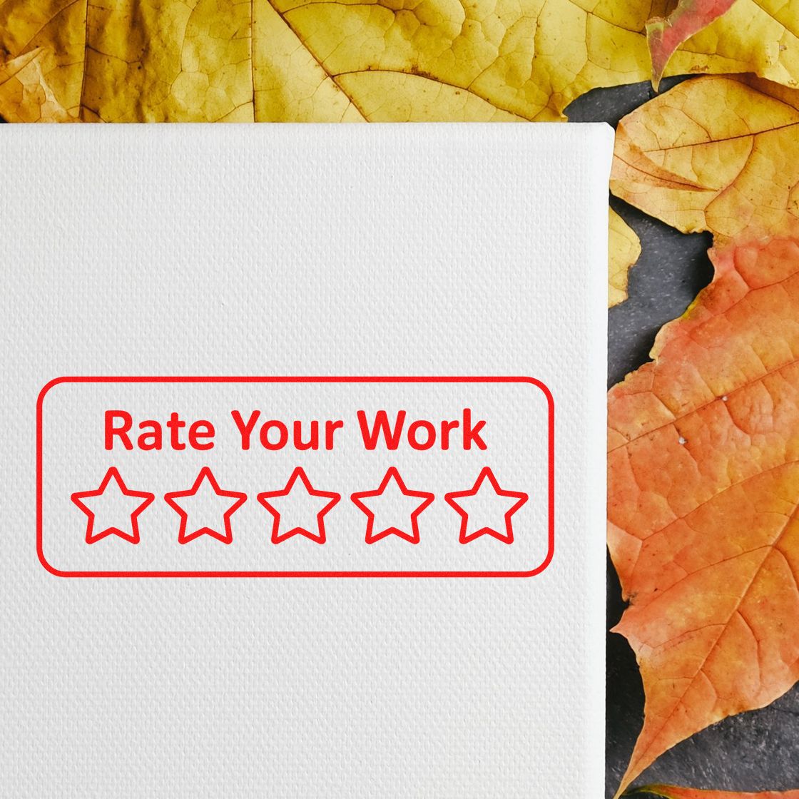 Red stamp seal reading Rate Your Work with five stars on white canvas, framed by yellow and orange autumn leaves.