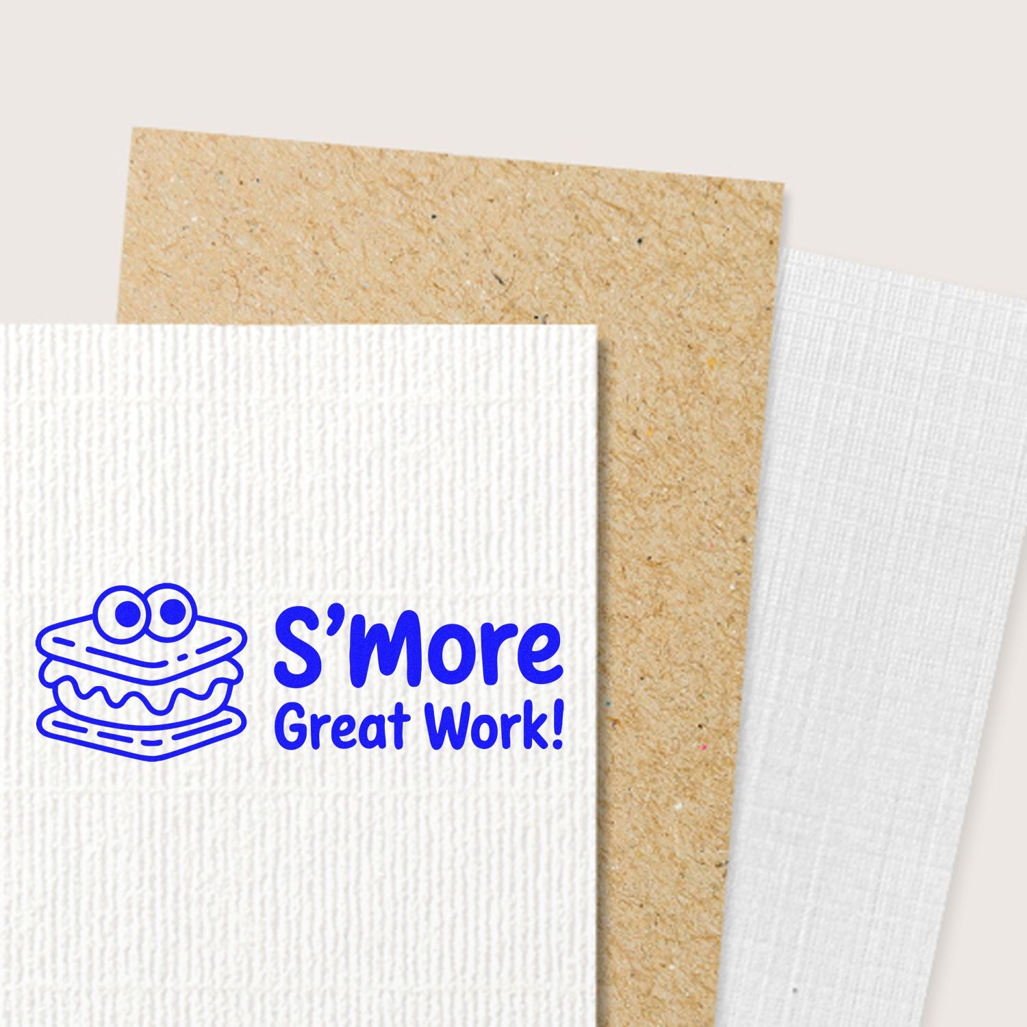 Blue Smore Great Work! stamp with smore icon on white textured card, shown with kraft and white seal paper samples.