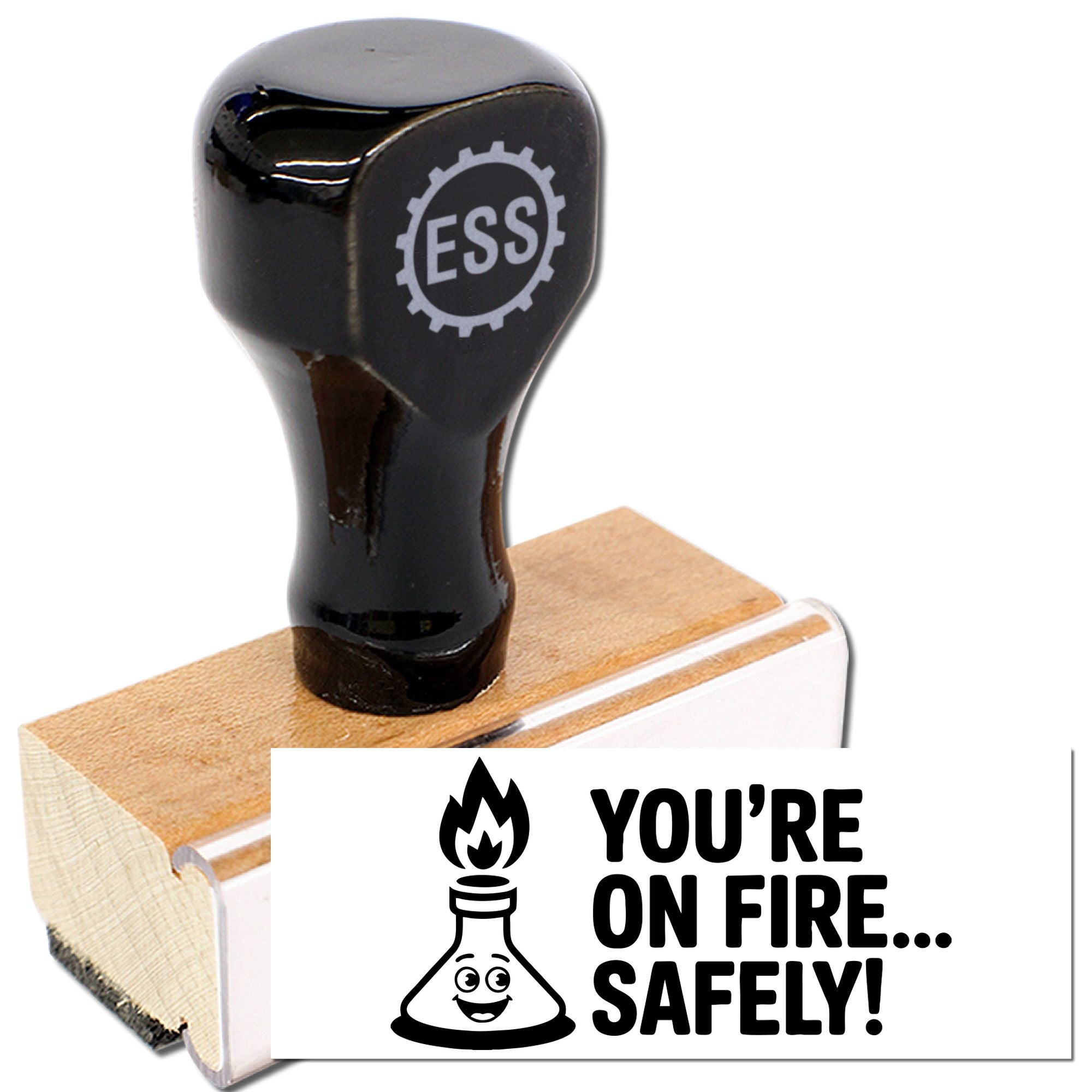 Black ESS rubber stamp seal on wood block with white YOURE ON FIRE... SAFELY! fire extinguisher design