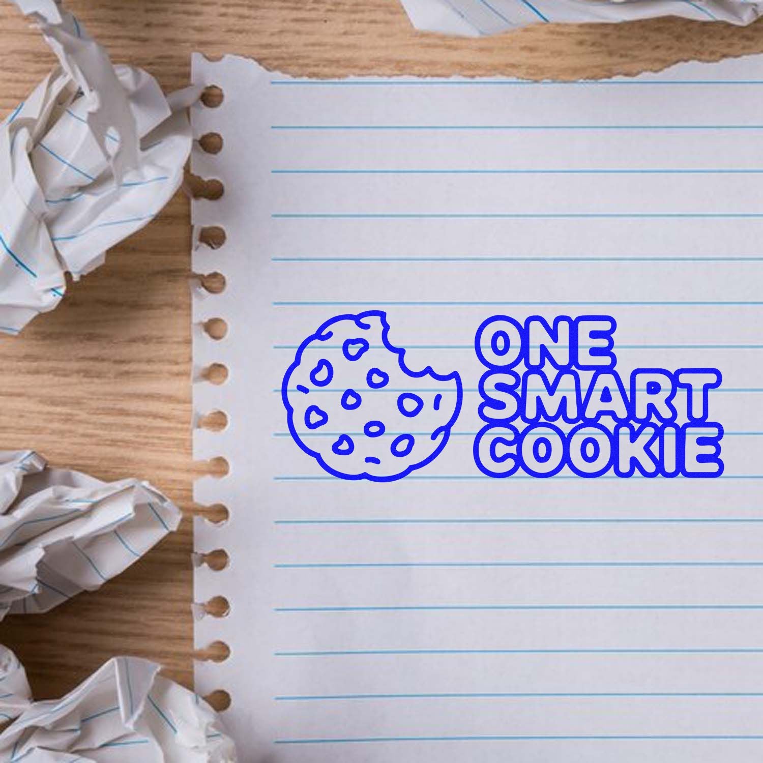 Blue One Smart Cookie cookie stamp and seal design on lined notebook paper with crumpled paper accents.