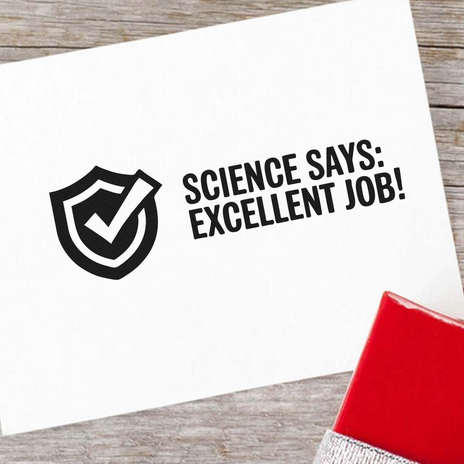 Black seal stamp with shield checkmark and Science says: Excellent job! on white card, beside red stamp pad.