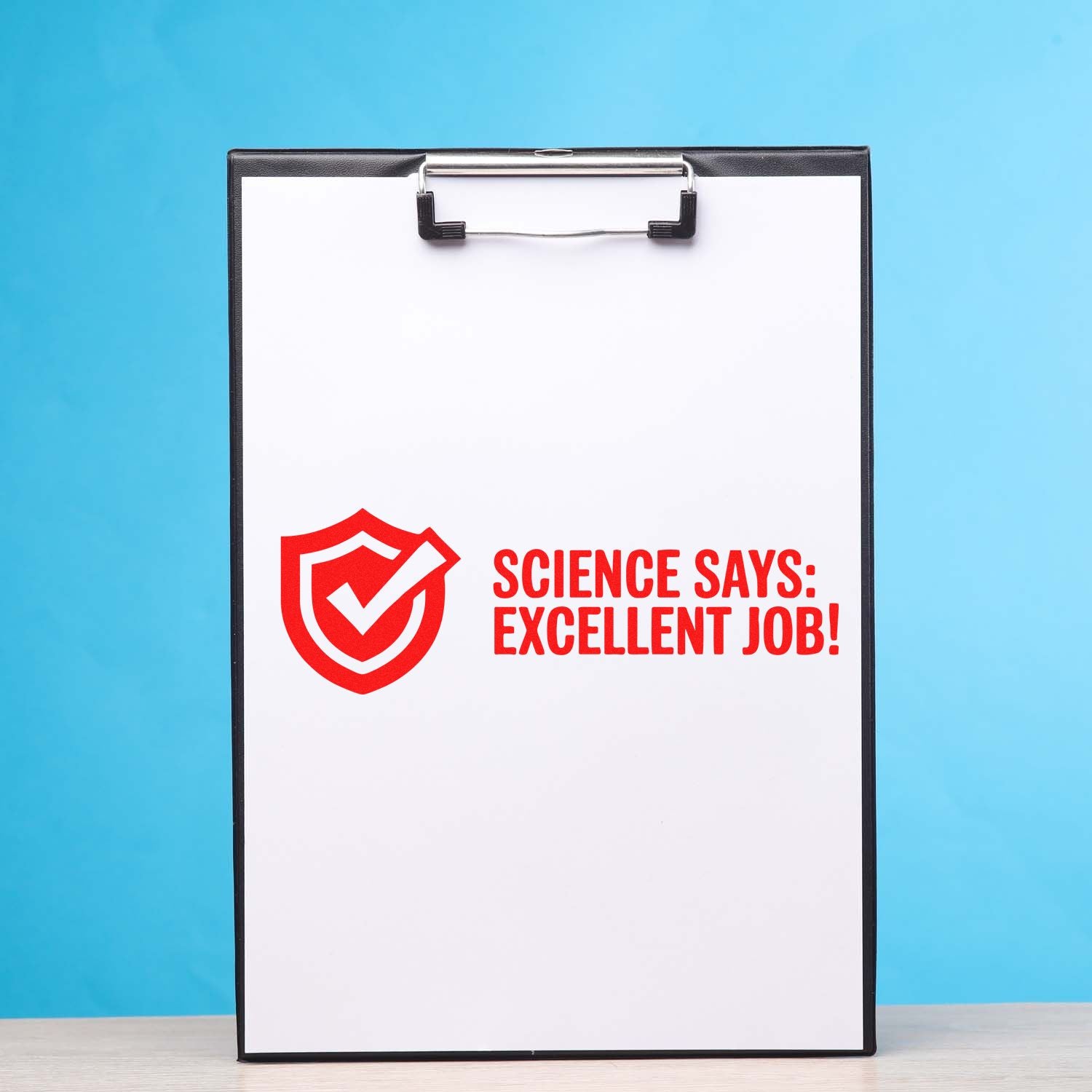 Black clipboard stamp and seal with red shield checkmark and Science Says: Excellent Job! on white sheet, blue background.