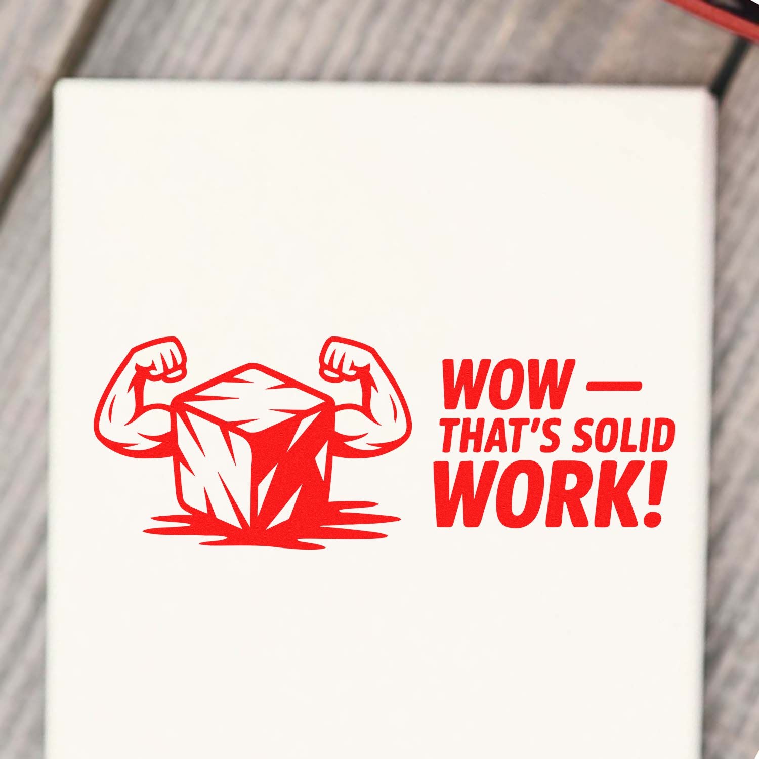 Red stamp/seal design with flexing arms around a faceted stone and bold WOW THATS SOLID WORK! on white background.