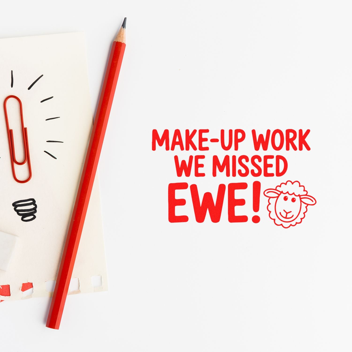 Custom red rubber stamp reading Make-up work we missed EWE! with sheep icon, beside a red pencil and paper clips.