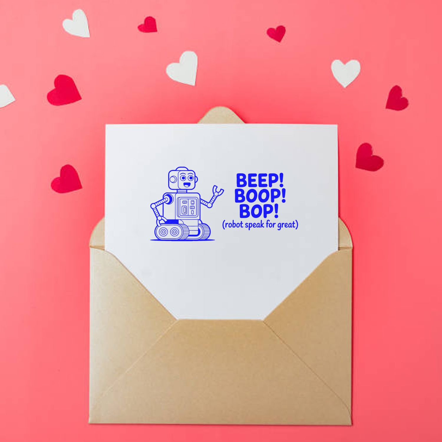 Blue robot stamp and seal reading BEEP! BOOP! BOP! on a white card in a beige envelope, with pink heart confetti.