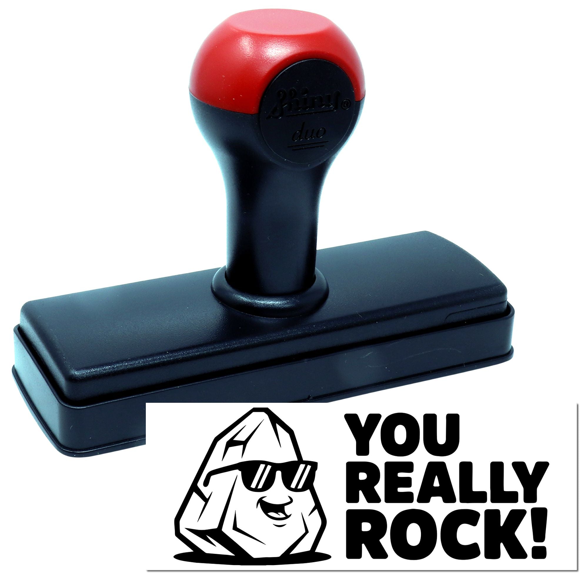 Red and black self-inking stamp with a You Really Rock! seal design and cartoon rock graphic.