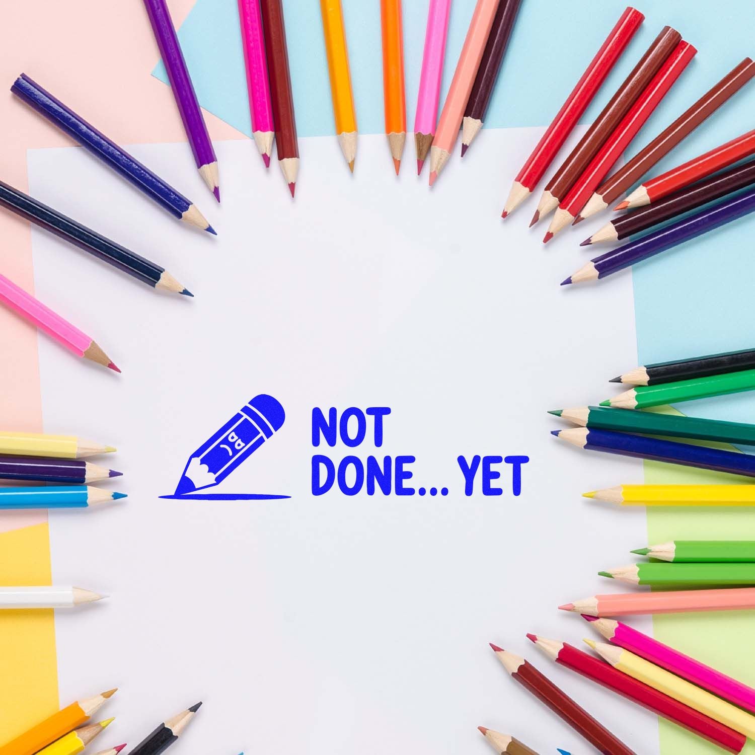 Blue pencil stamp seal reading Not Done... Yet, surrounded by colorful pencils on a pastel background.