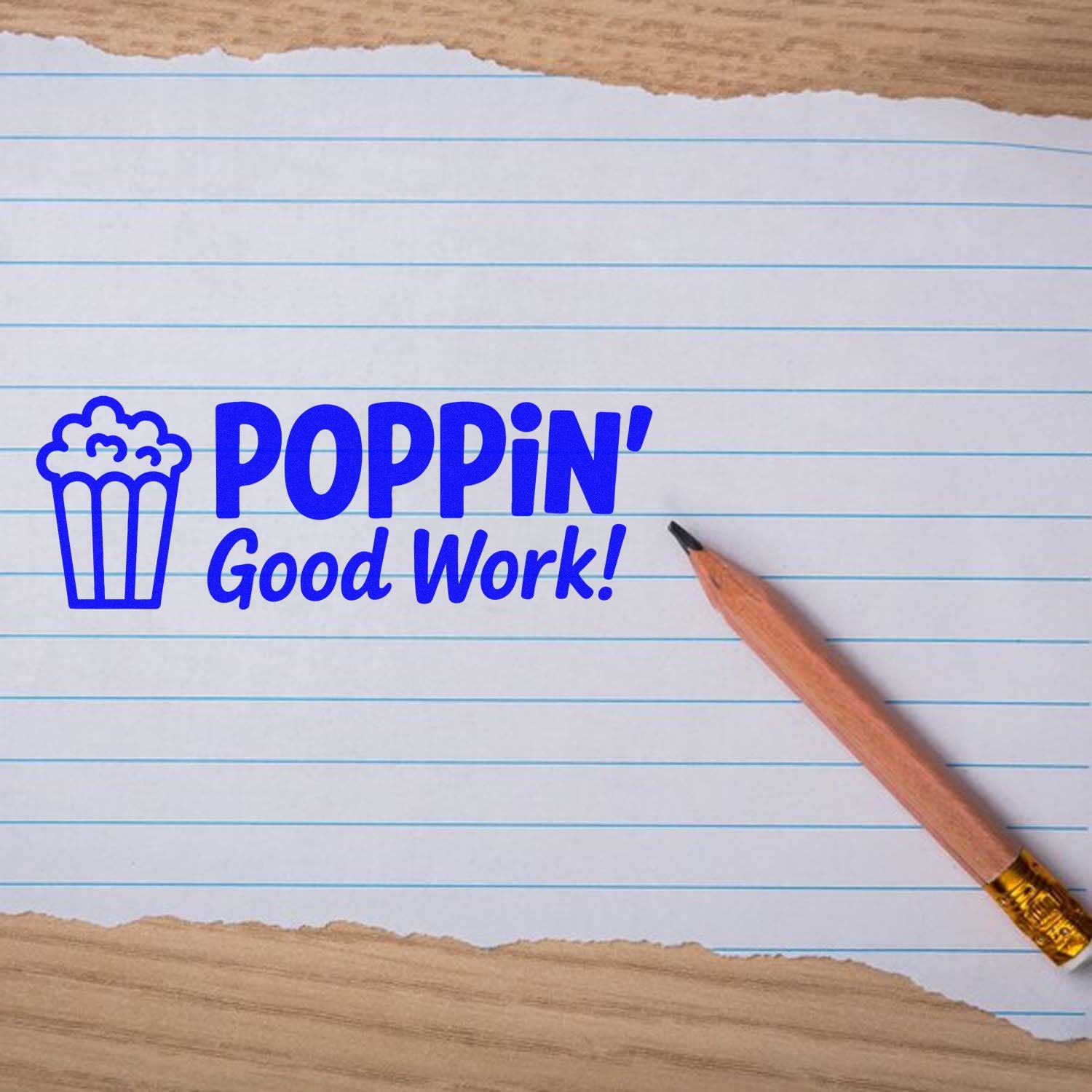 Blue popcorn reward stamp and seal reading POPPIN Good Work! on lined paper with pencil.