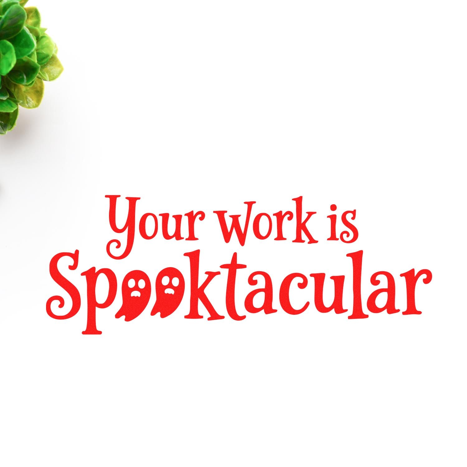 Red Your work is Spooktacular rubber stamp seal on white background, with ghost-eyed letters and green foliage corner.