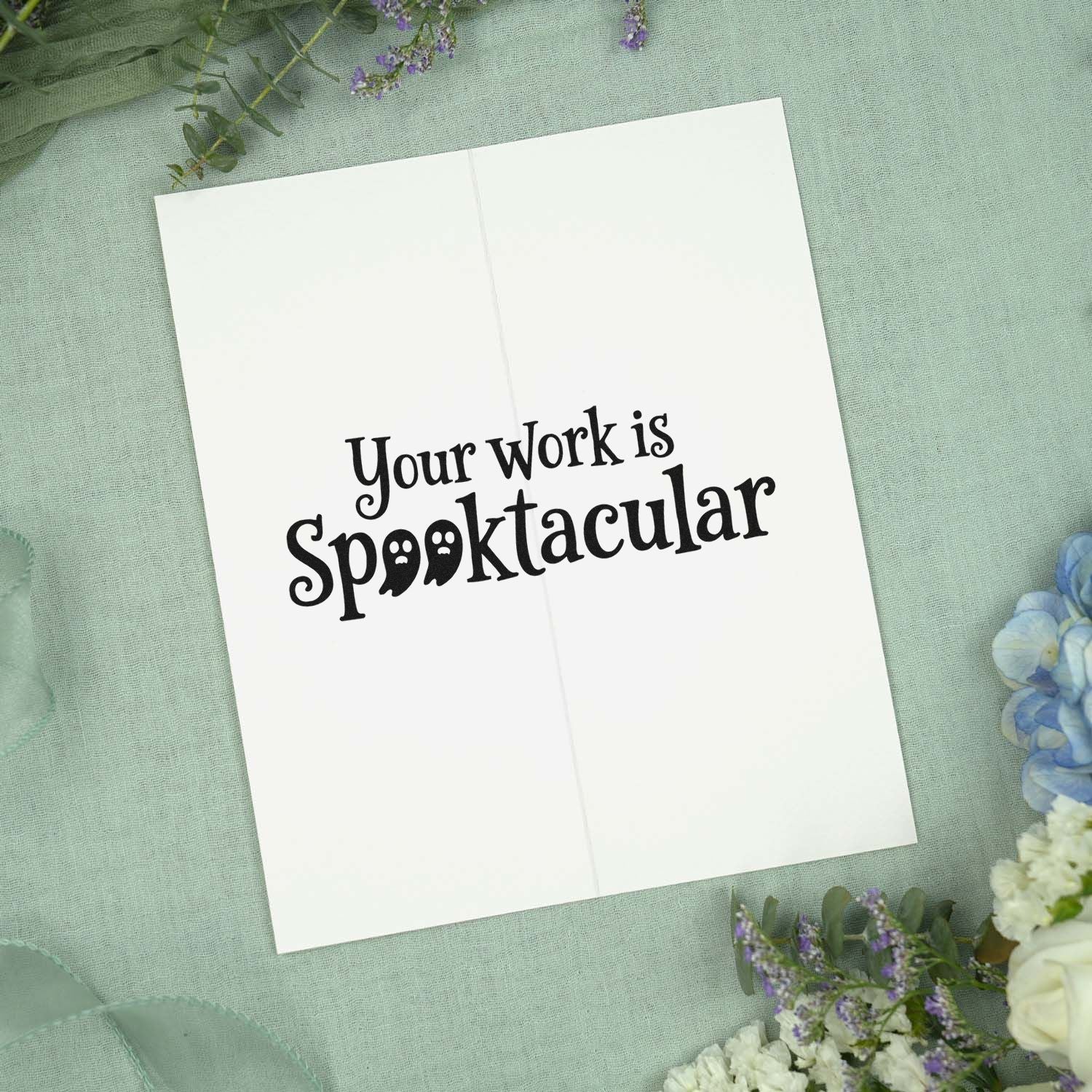 Halloween stamp and seal reading Your Work is Spooktacular on a white folded card with sage green and purple floral accents.