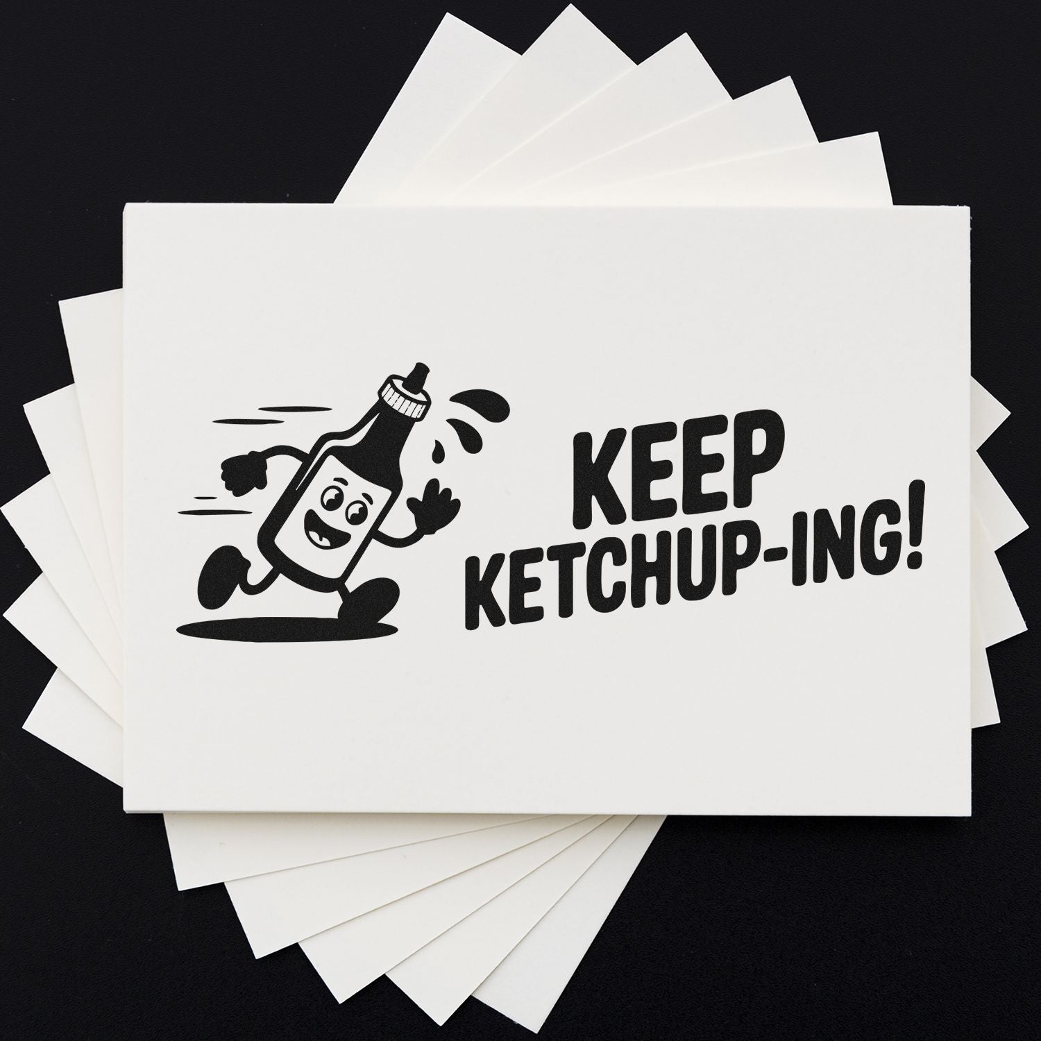 Black ketchup stamp on white seal cards, featuring a cartoon bottle and KEEP KETCHUP-ING! text.