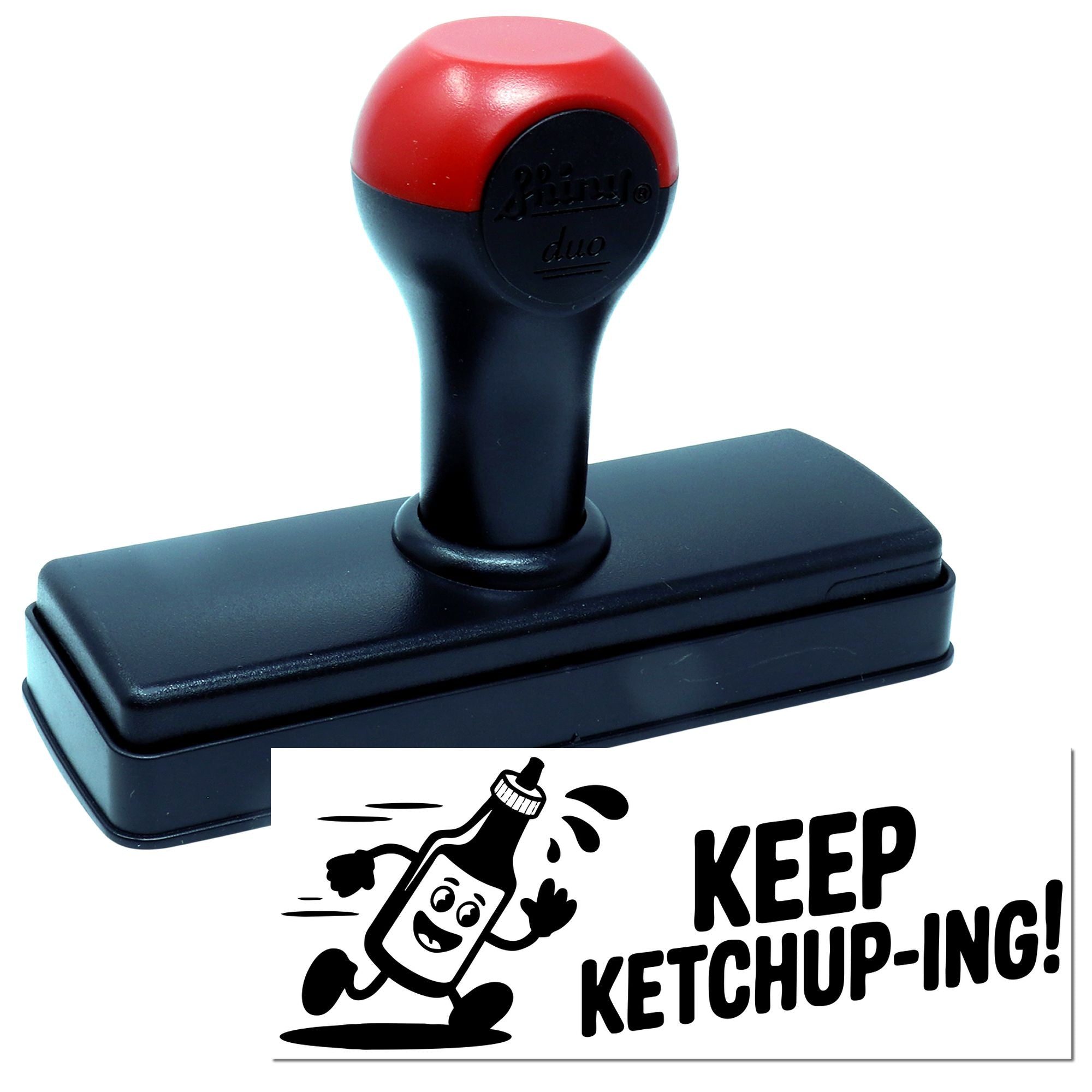 Black self-inking stamp with red handle, showing a custom seal that says KEEP KETCHUP-ING! with a cartoon ketchup bottle.