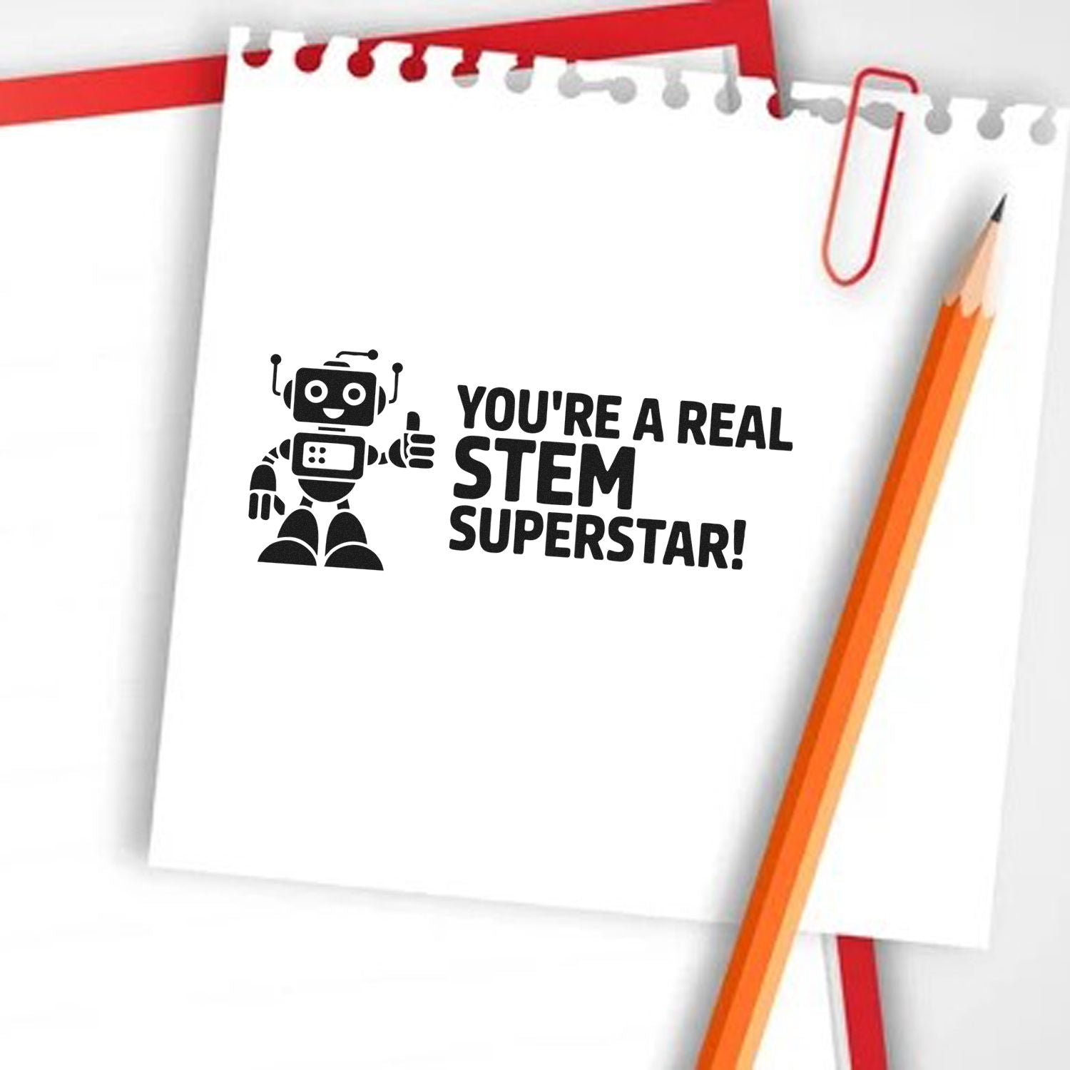 Black STEM Superstar stamp design on white notebook paper, with robot icon, red paperclip, and orange pencil.