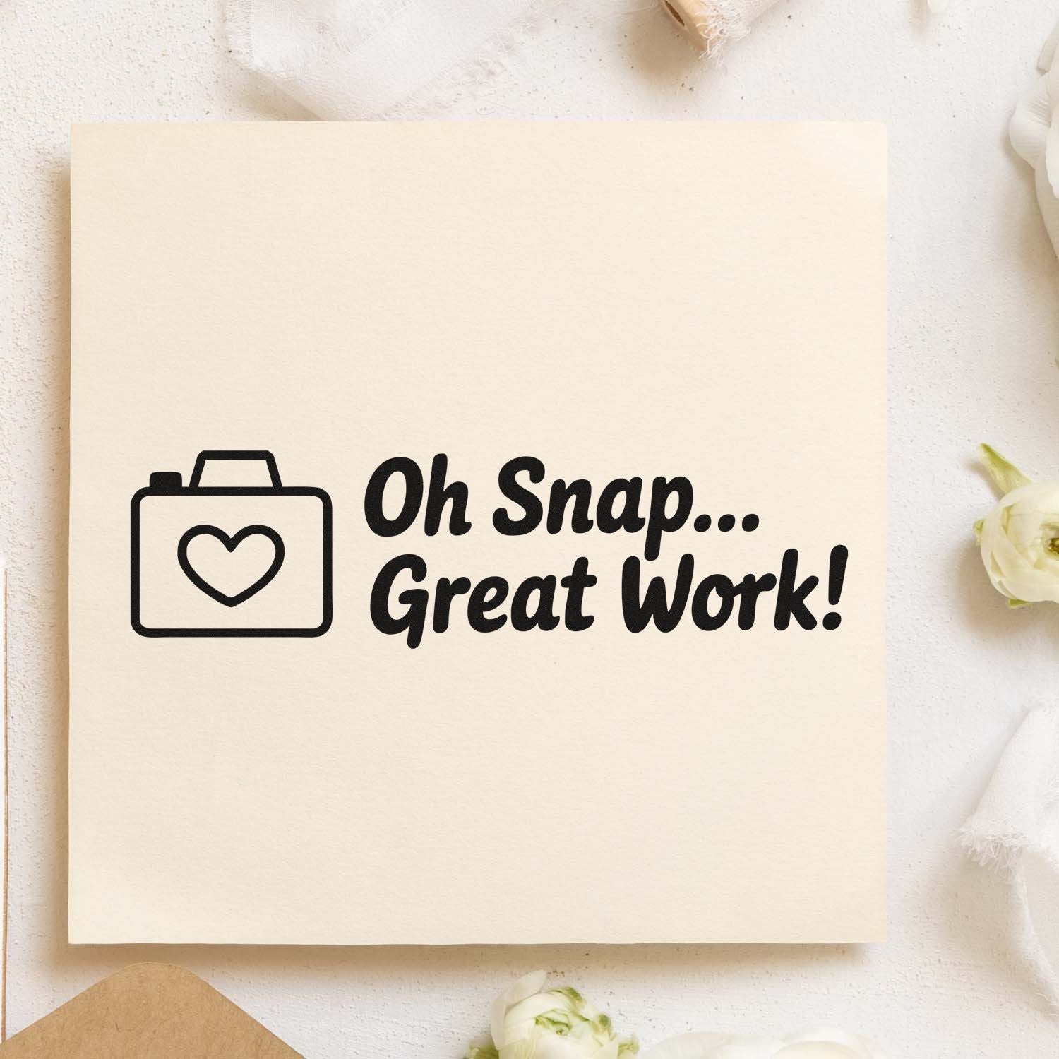 Black stamp seal with heart briefcase icon and Oh Snap... Great Work! on cream background with white flowers.