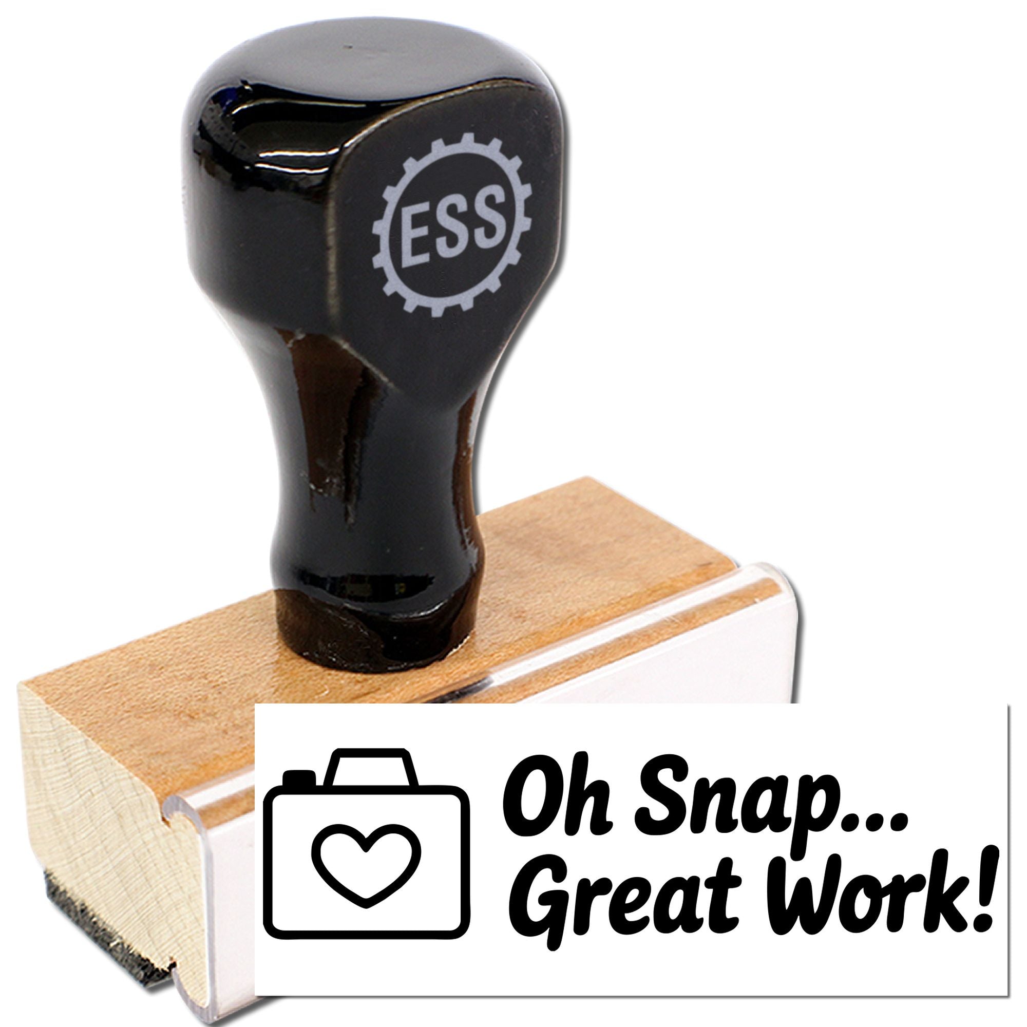 Black ESS stamp seal on a wood base, with a white Oh Snap... Great Work! card and heart icon.