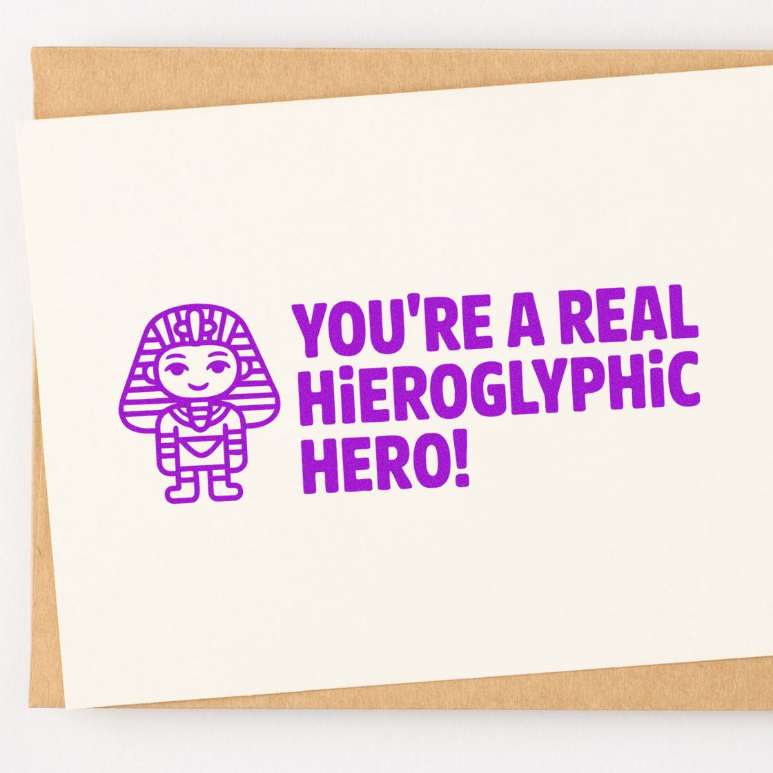 Purple pharaoh stamp and seal design with YOURE A REAL HIEROGLYPHIC HERO! on a cream card.