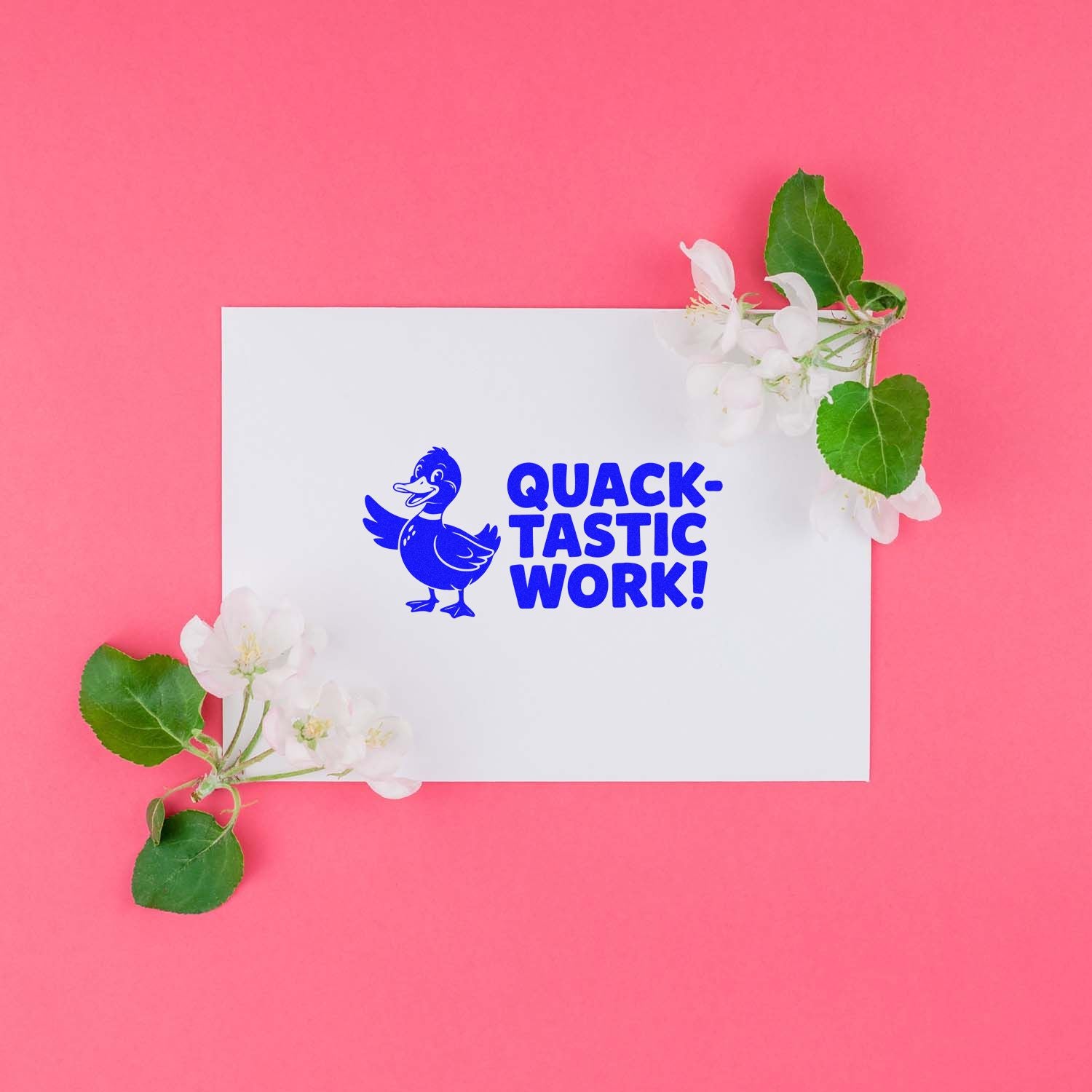 White stamp and seal card with blue duck and QUACK-TASTIC WORK! on pink background, accented by white flowers and green leaves.