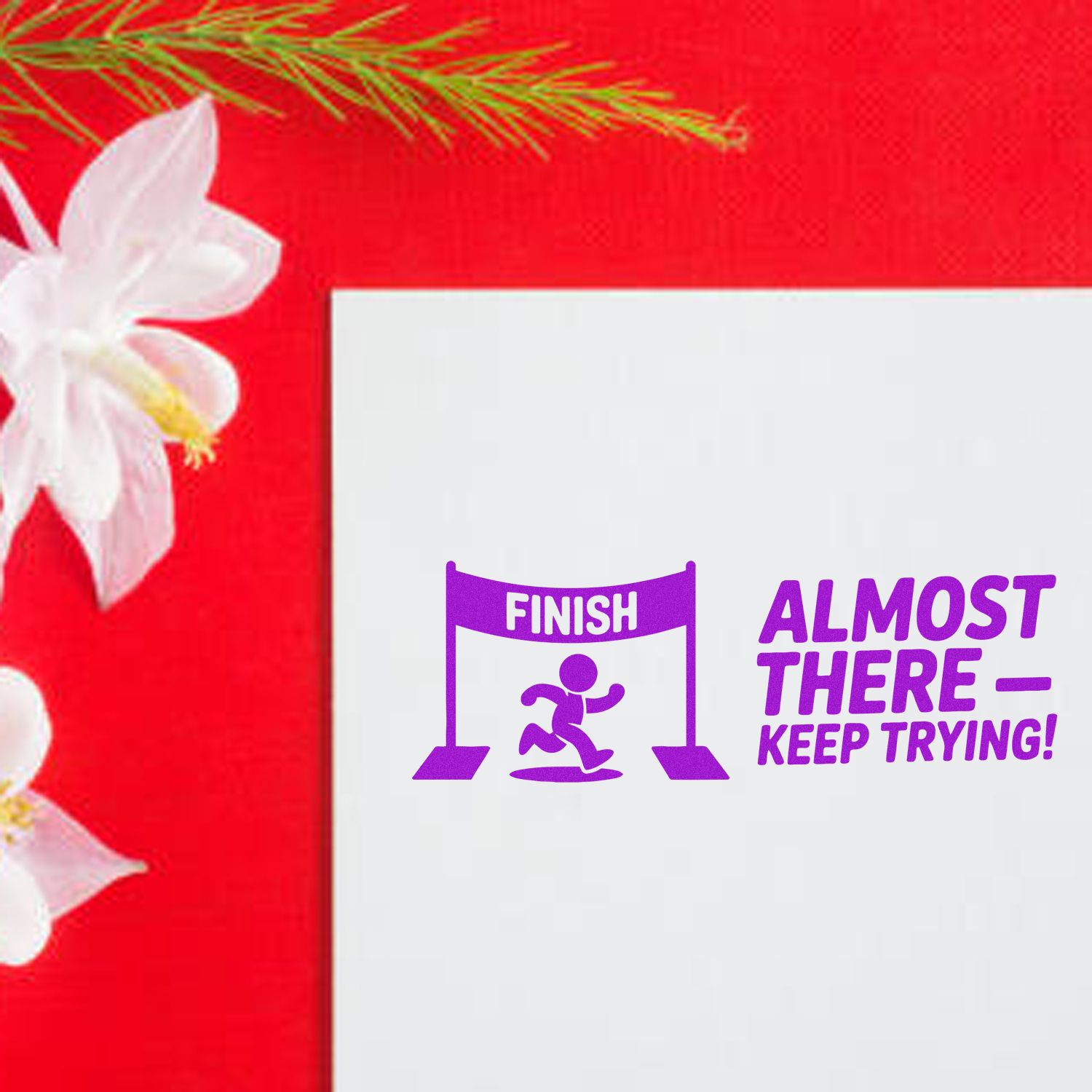 Purple finish-line stamp and seal design with runner, Almost ThereKeep Trying! on white paper over a red floral background.