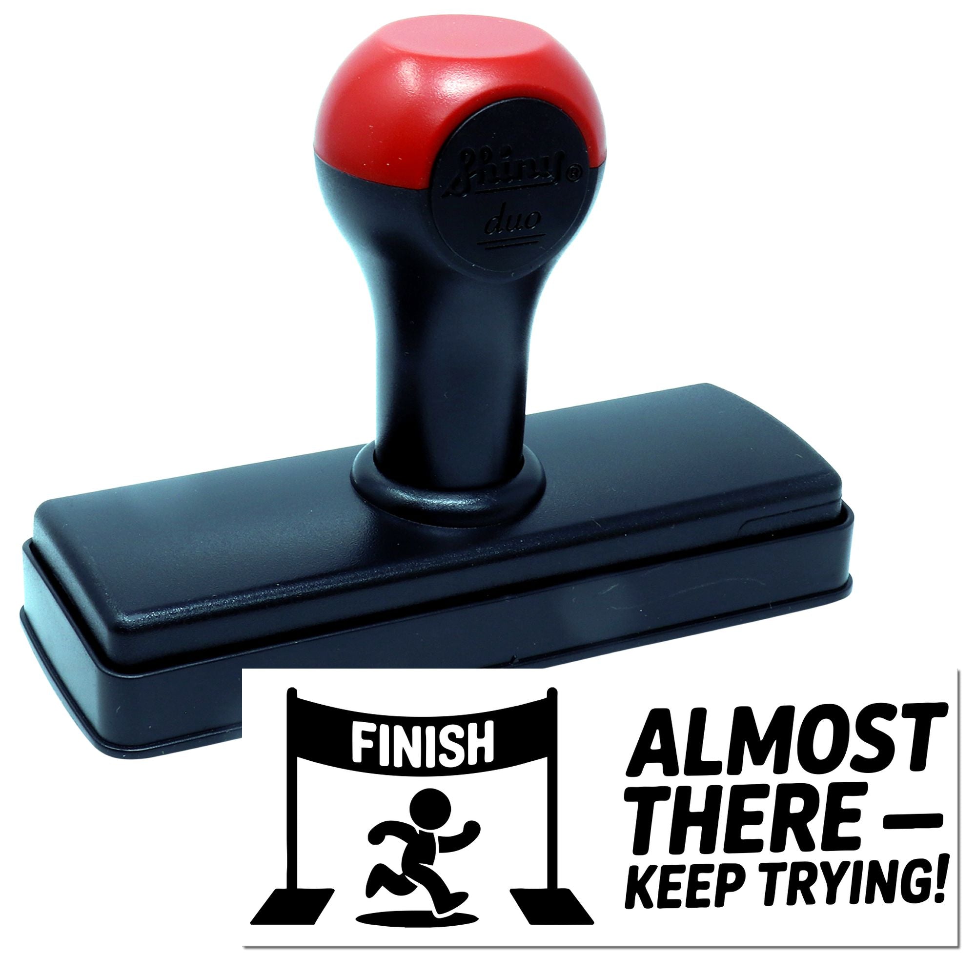 Red and black self-inking stamp and seal with rectangular finish impression and Almost therekeep trying text.