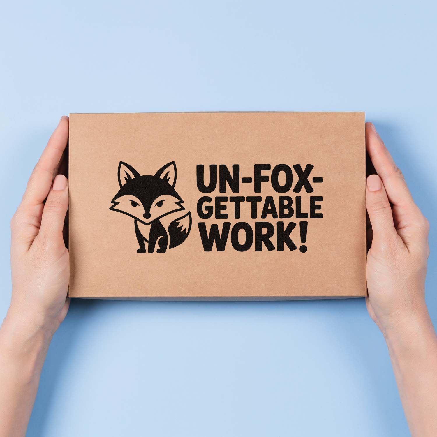 Hands holding kraft box with black fox logo and custom stamp-style seal reading UN-FOX-GETTABLE WORK! on light blue background.