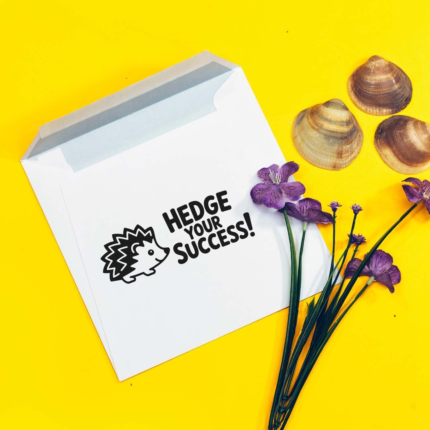 White stamp-and-seal envelope with black hedgehog logo and slogan on bright yellow, accented by shells and purple flowers.