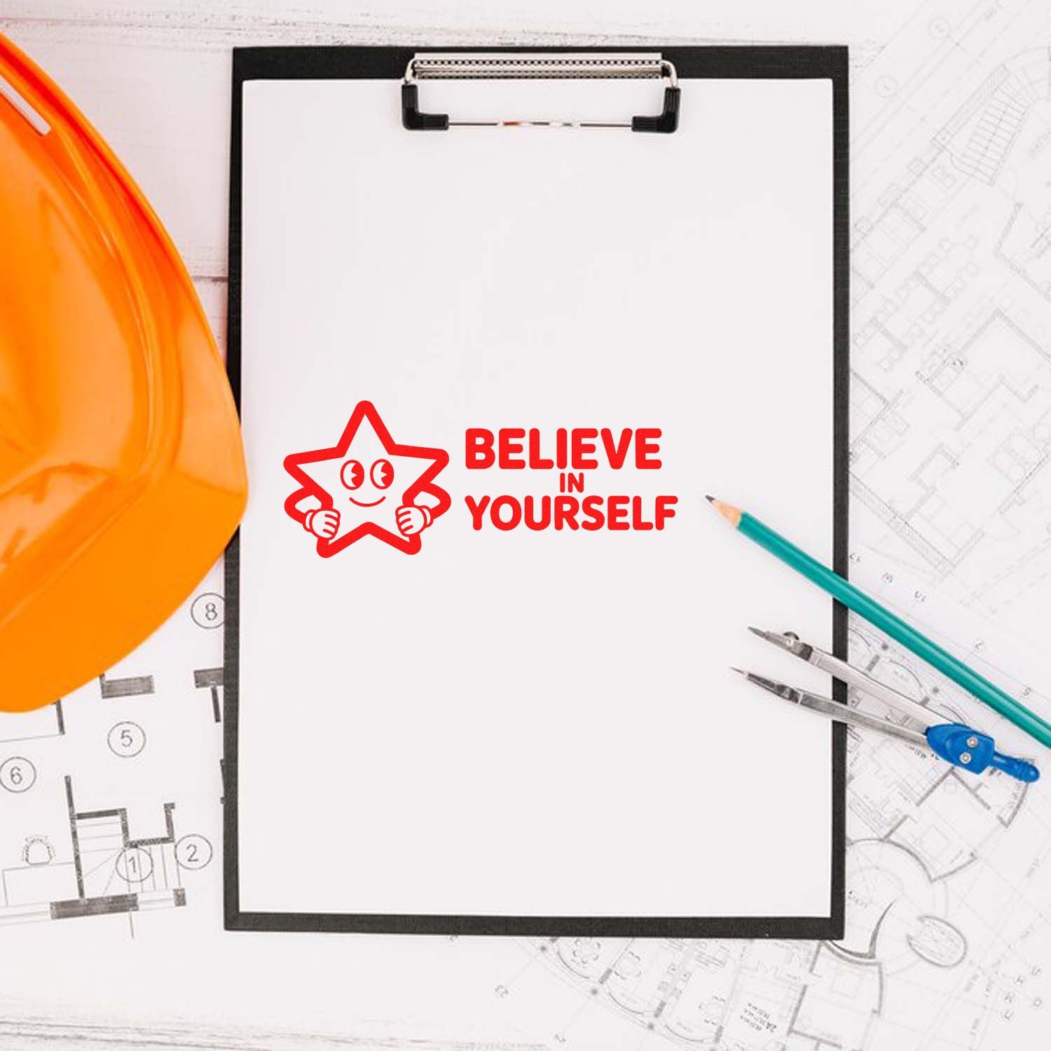 Red Believe in Yourself stamp seal on clipboard with orange hard hat, pencils, and drafting tools over blueprints.