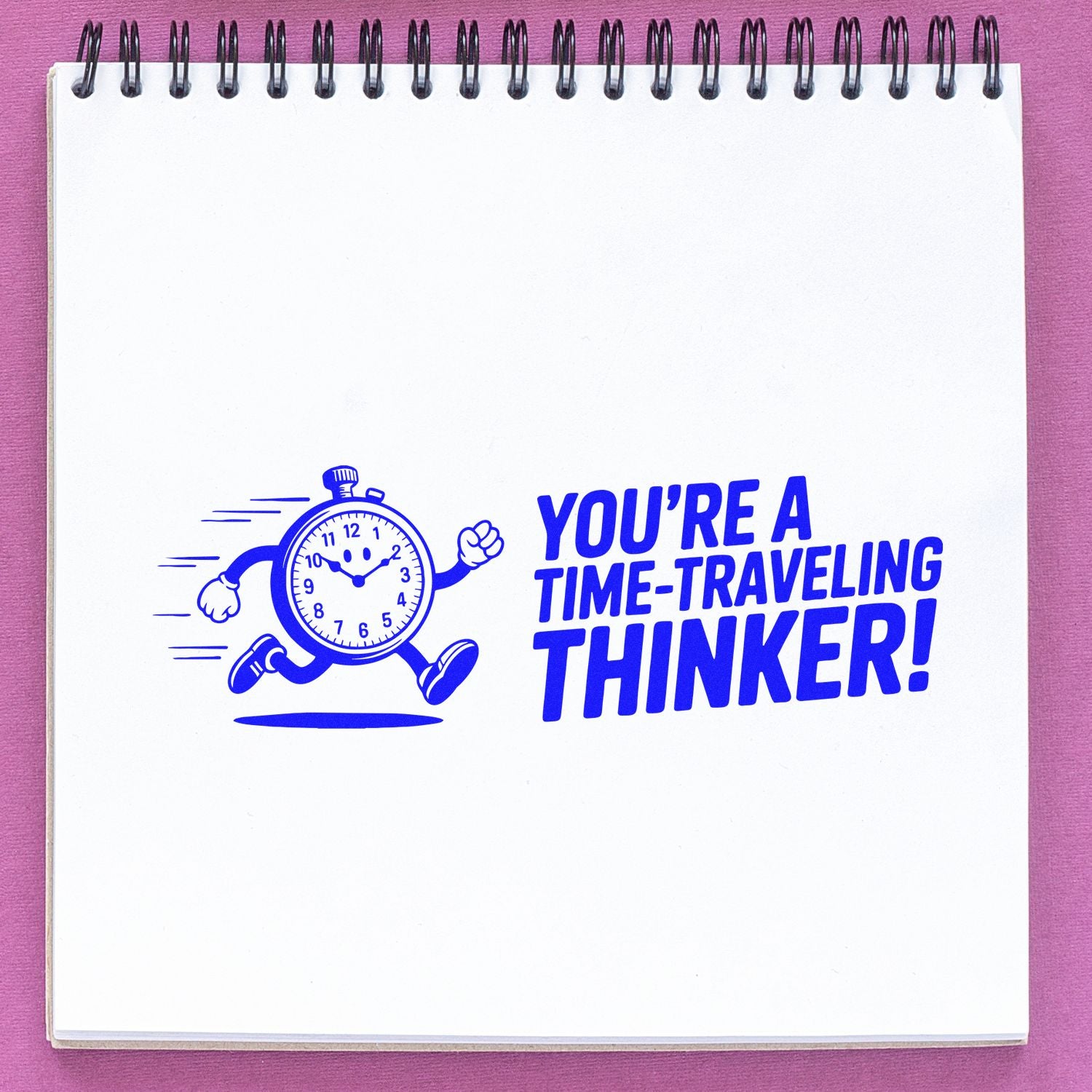 Blue stamp seal on white notebook page: running stopwatch cartoon and bold text Youre a time-traveling thinker! on pink background.