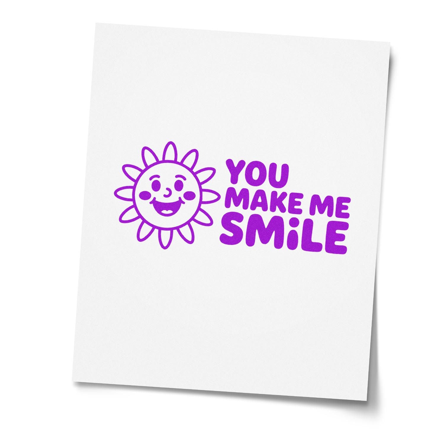 Purple smiley sun rubber stamp and seal design with You Make Me Smile in bold purple on white paper.
