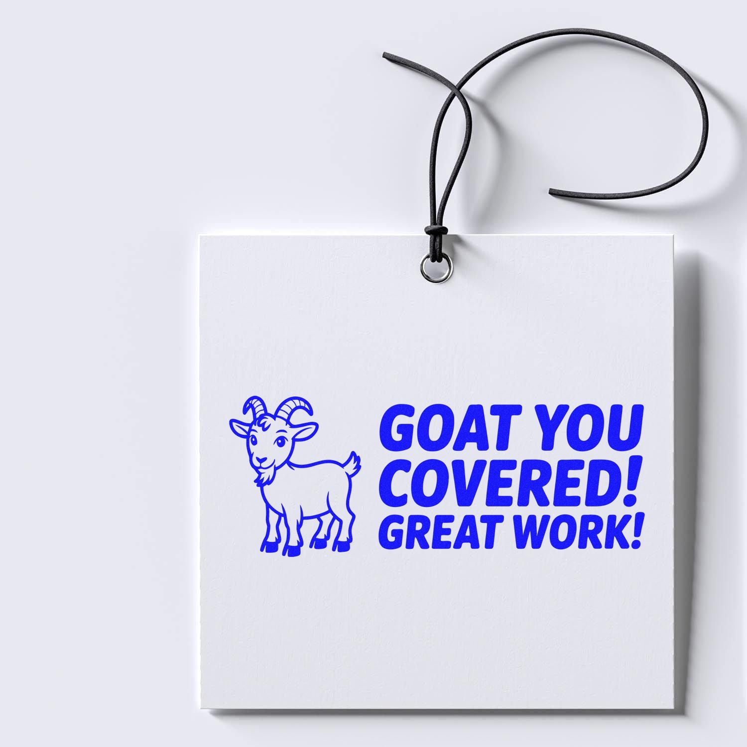 Blue custom stamp seal with goat graphic on a white hanging tag, reading GOAT YOU COVERED! GREAT WORK!