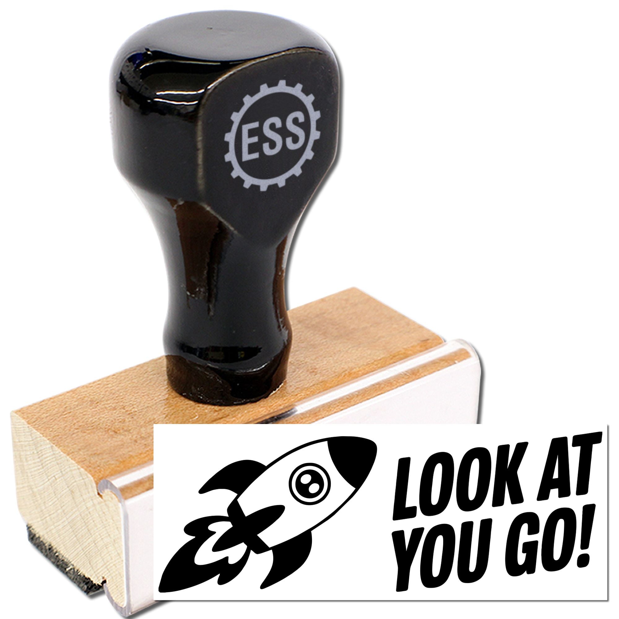 Black ESS rubber stamp on wooden base with rocket seal and LOOK AT YOU GO! impression.