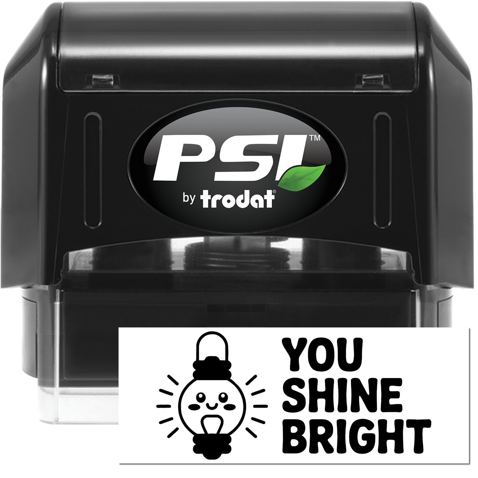 Black PSI by Trodat self-inking stamp and seal with clear base, green leaf logo, and white You Shine Bright impression card.