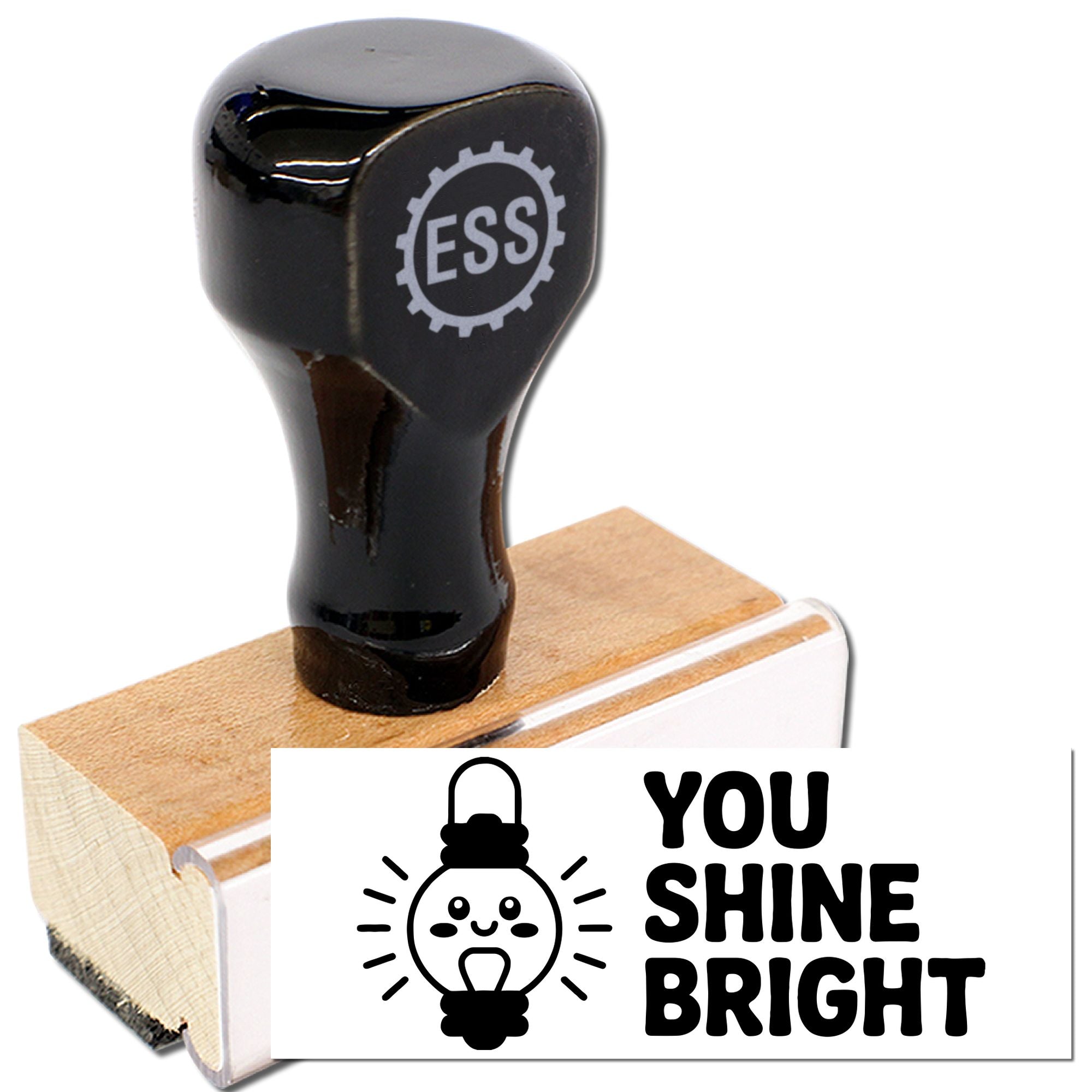 Black stamp and seal product on wooden base, featuring a light bulb icon and bold YOU SHINE BRIGHT text.