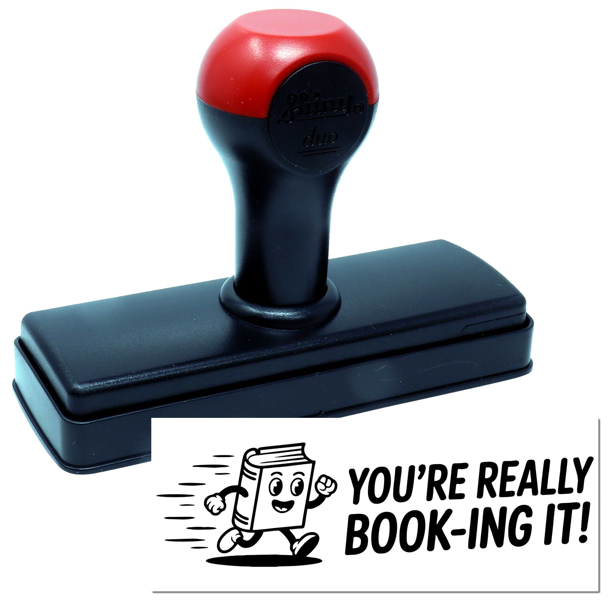 Red and black self-inking stamp with rectangular base and book-themed seal reading YOURE REALLY BOOK-ING IT!