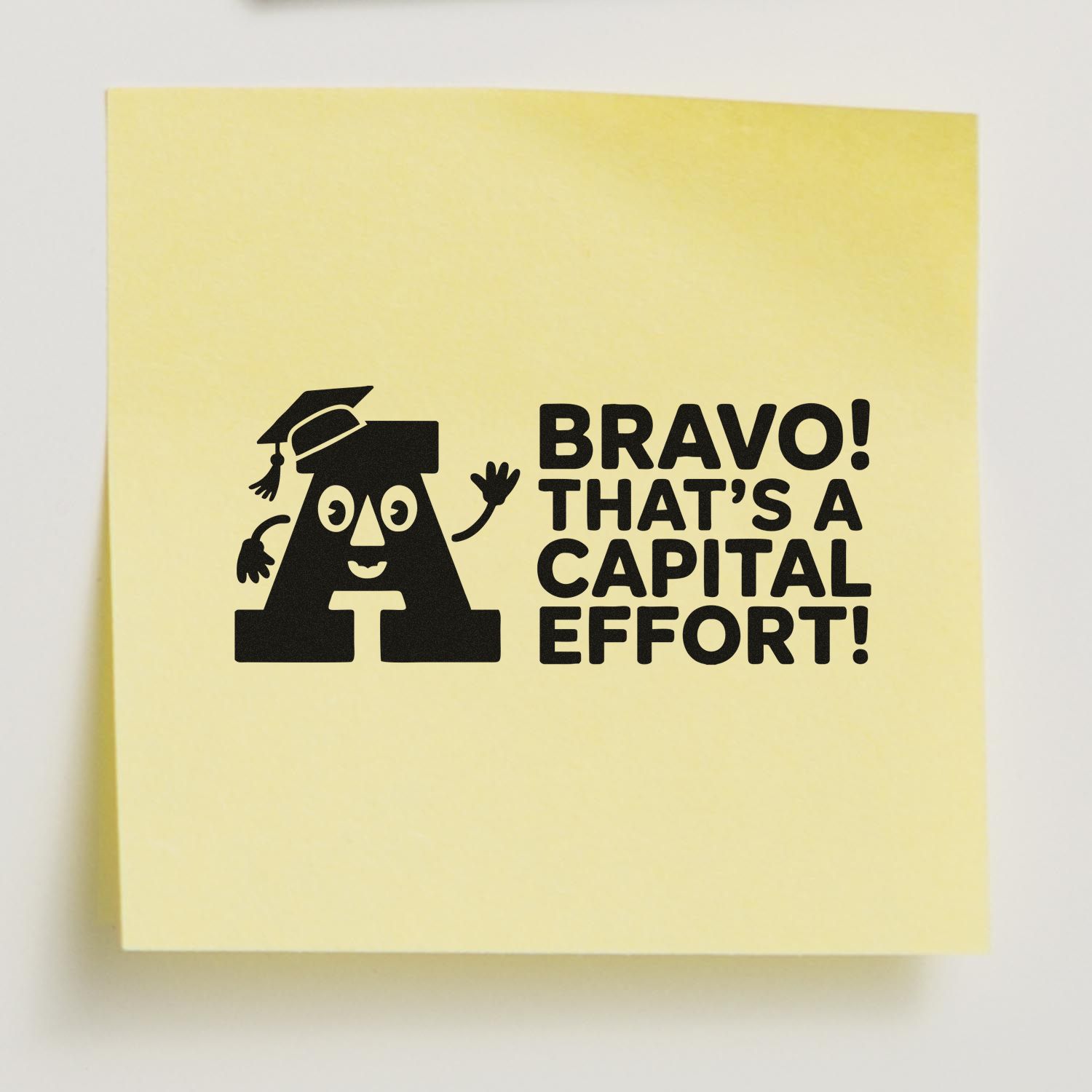 Yellow stamp seal with black capital A in graduation cap and bold text, Bravo! Thats a capital effort!