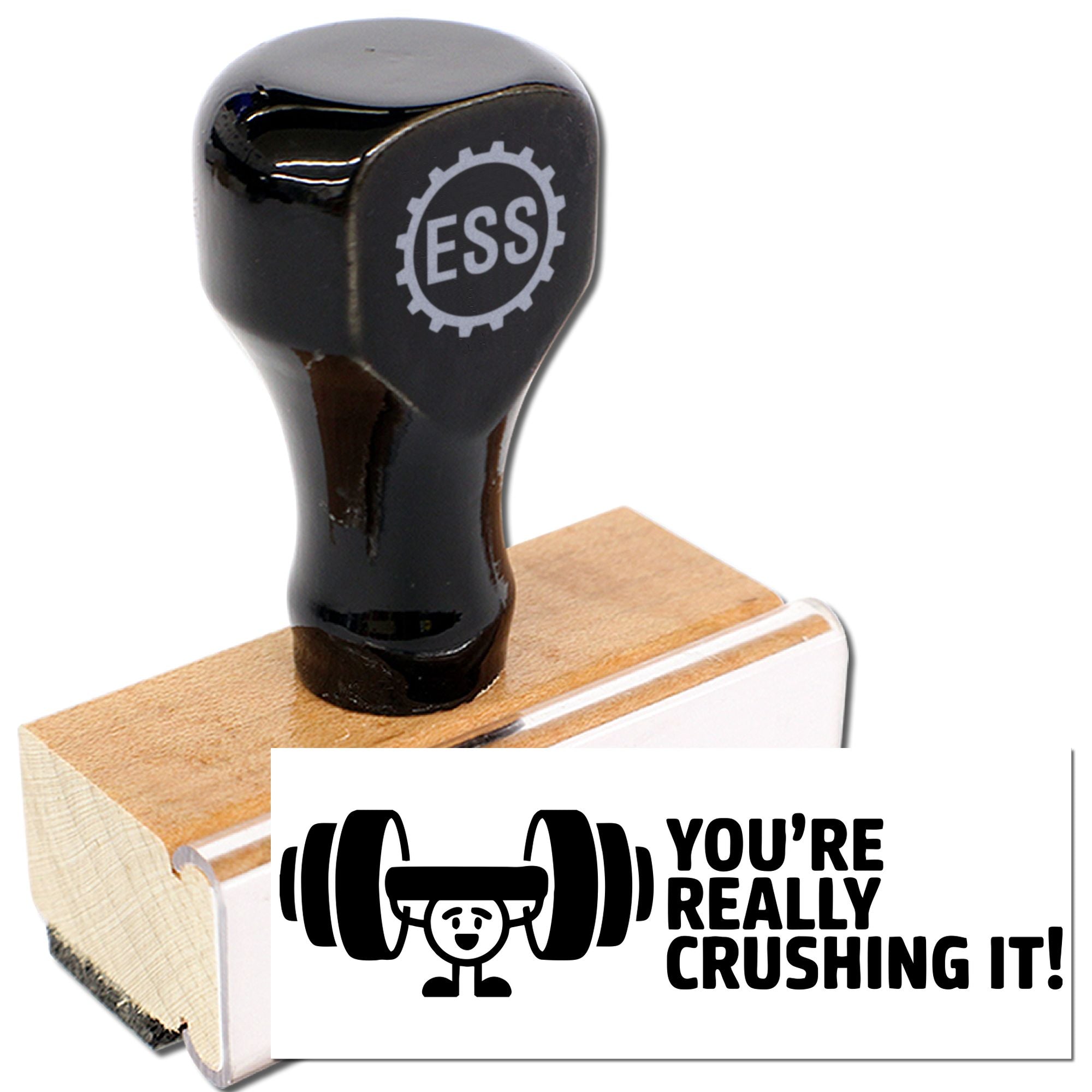 Black ESS stamp and seal on wooden block, with white Youre really crushing it! weightlifting design.