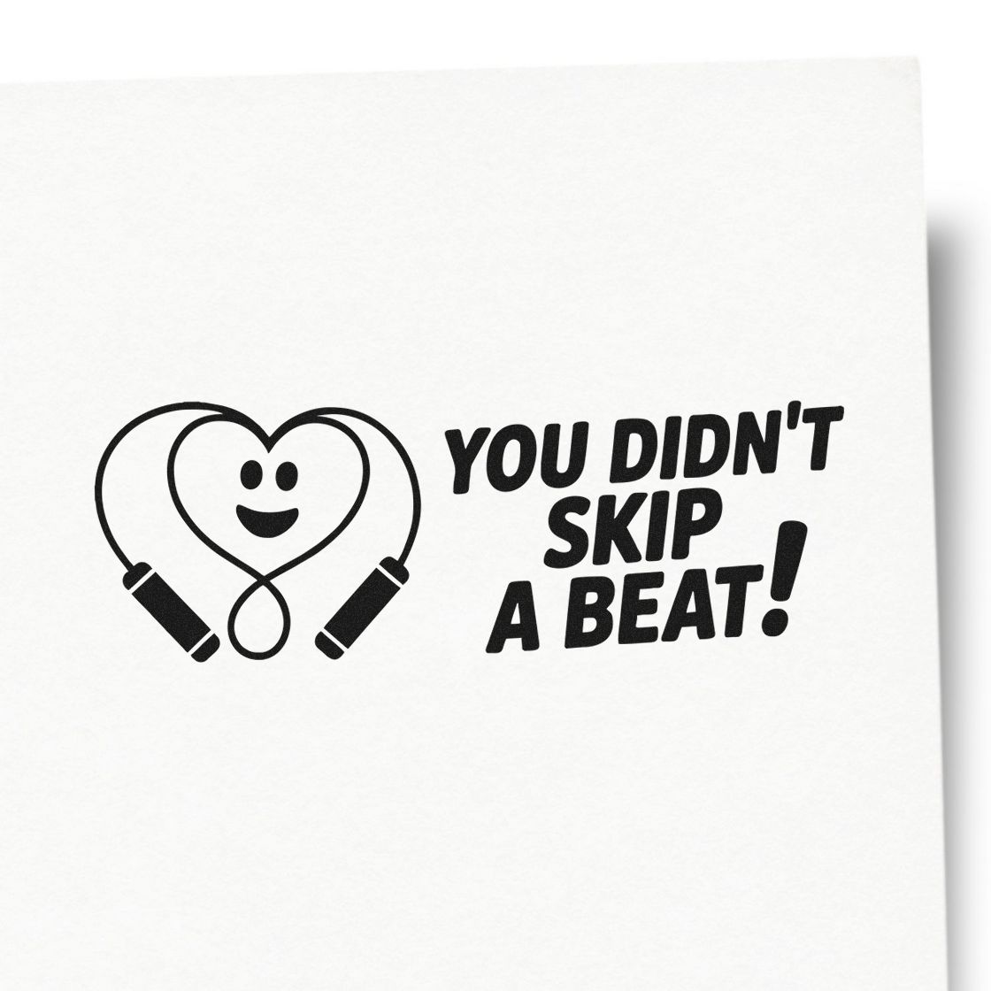 Black stamp design with heart-shaped jump rope and smiling face, reading "You didn't skip a beat!" on white background.