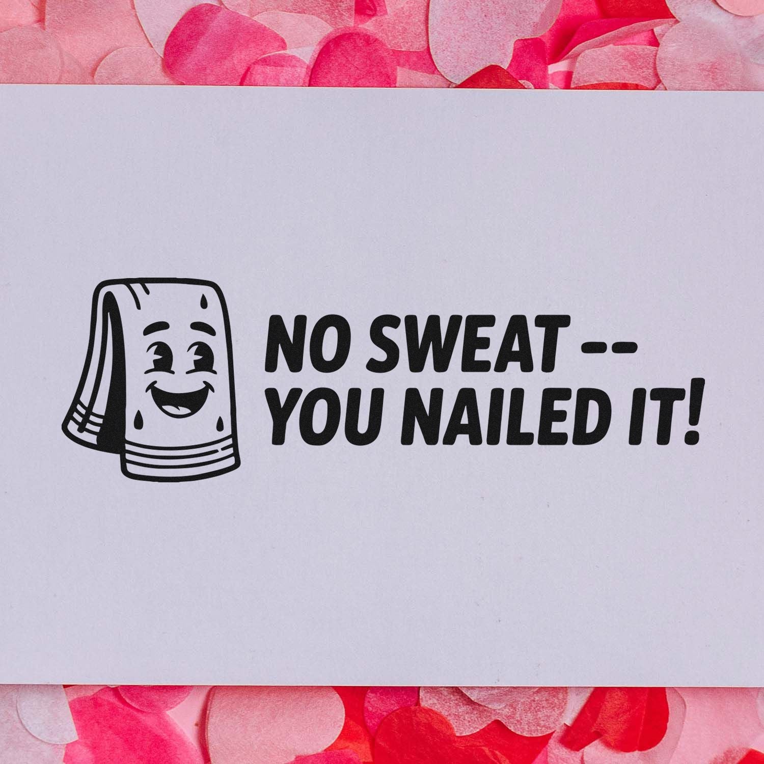 Black rubber stamp with smiling nail file and text No Sweat -- You Nailed It! on white card, pink confetti background.