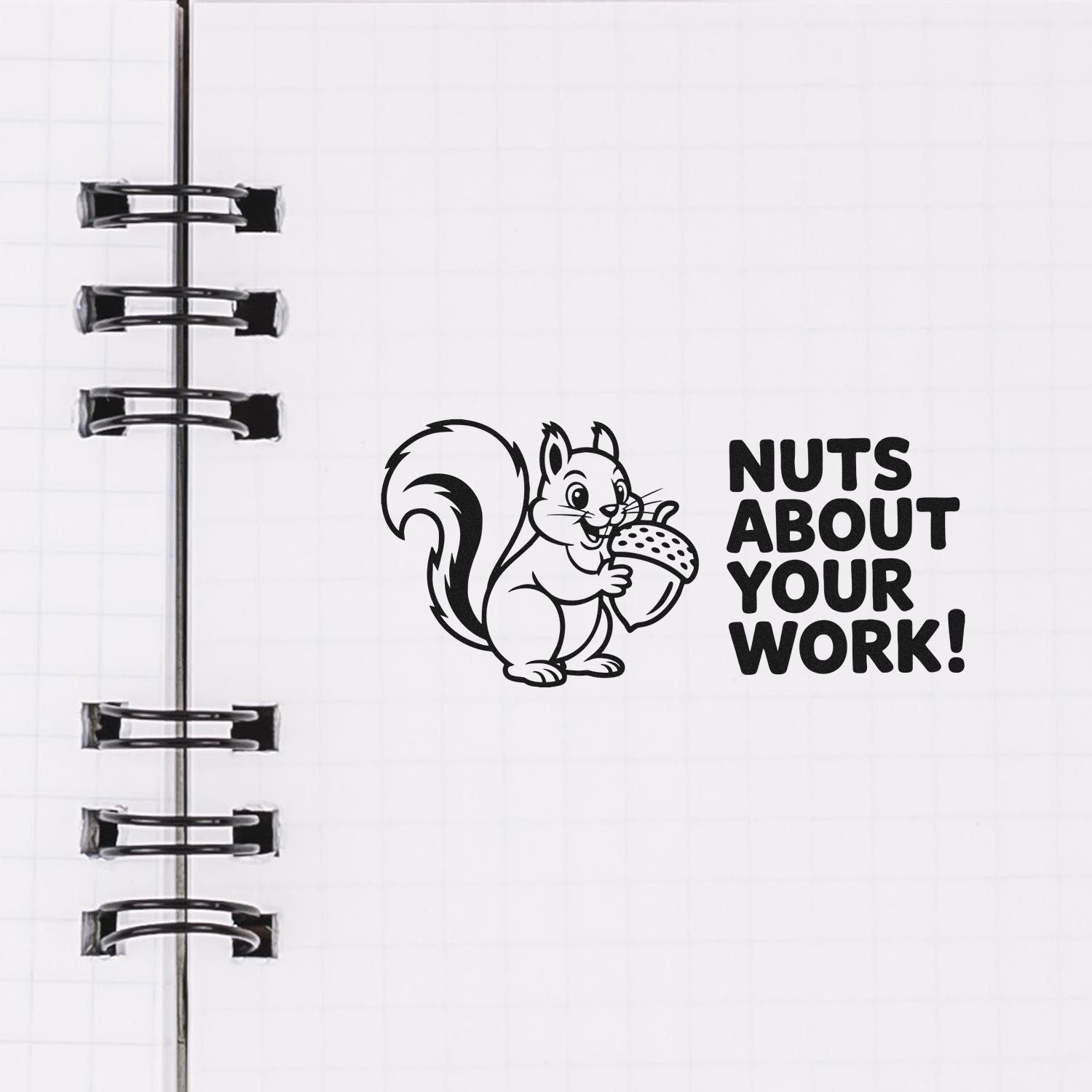 Black squirrel rubber stamp seal with NUTS ABOUT YOUR WORK! on a white notebook page, beside spiral binding.