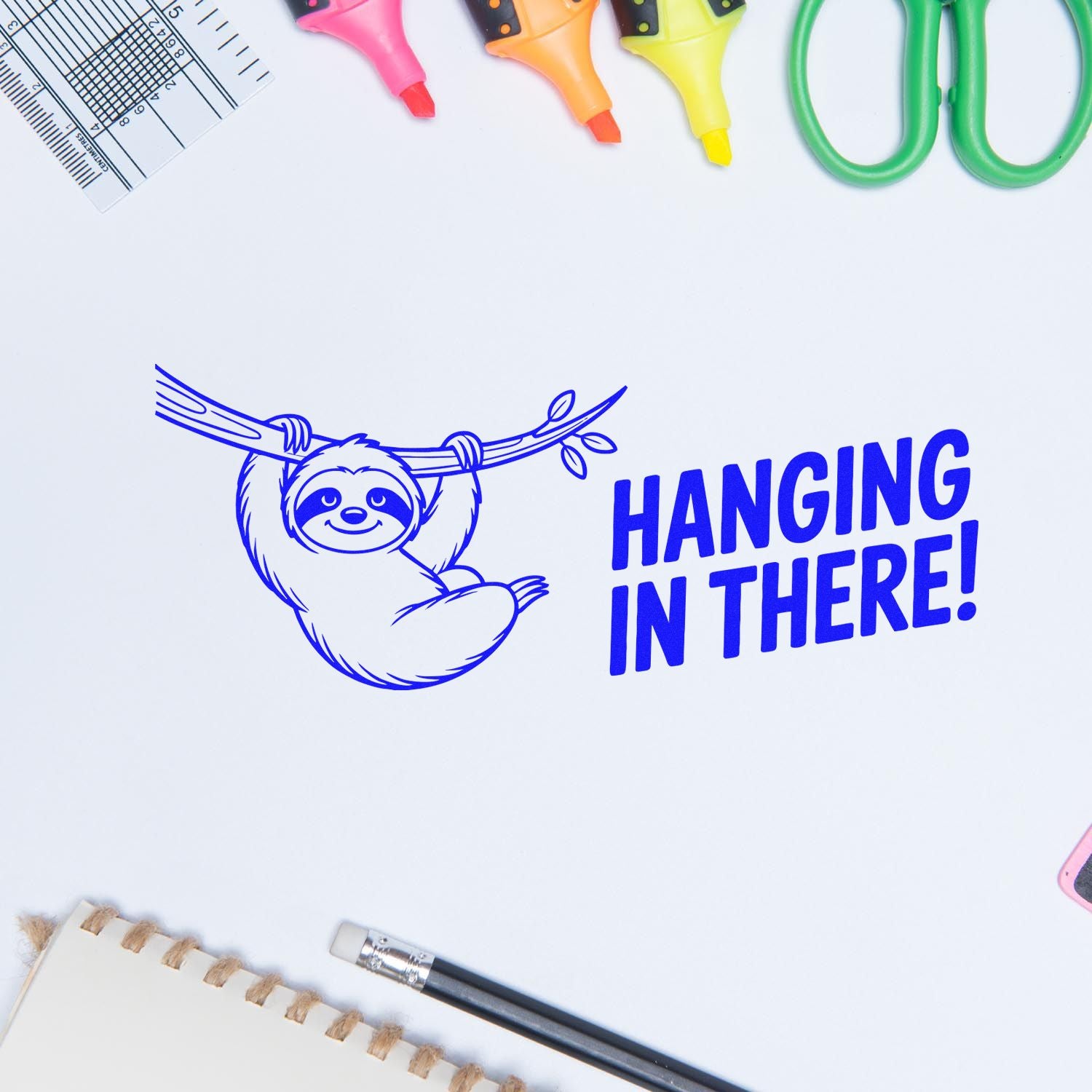 Blue sloth stamp with HANGING IN THERE! text, surrounded by pink, orange, yellow stamp and seal tools.