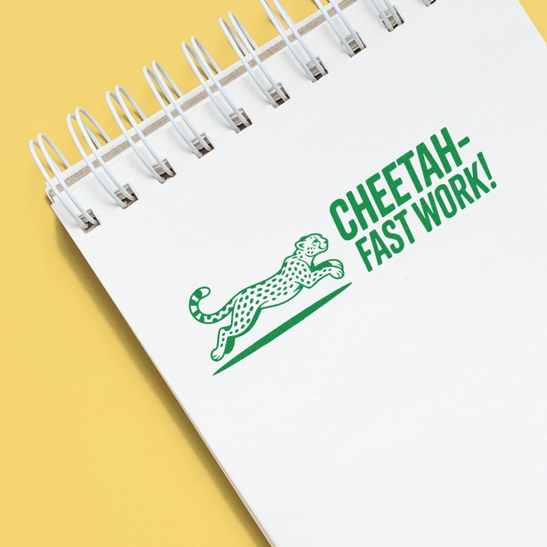 Green stamp and seal on white spiral notebook, with cheetah graphic and CHEETAH-FAST WORK! on a yellow background.